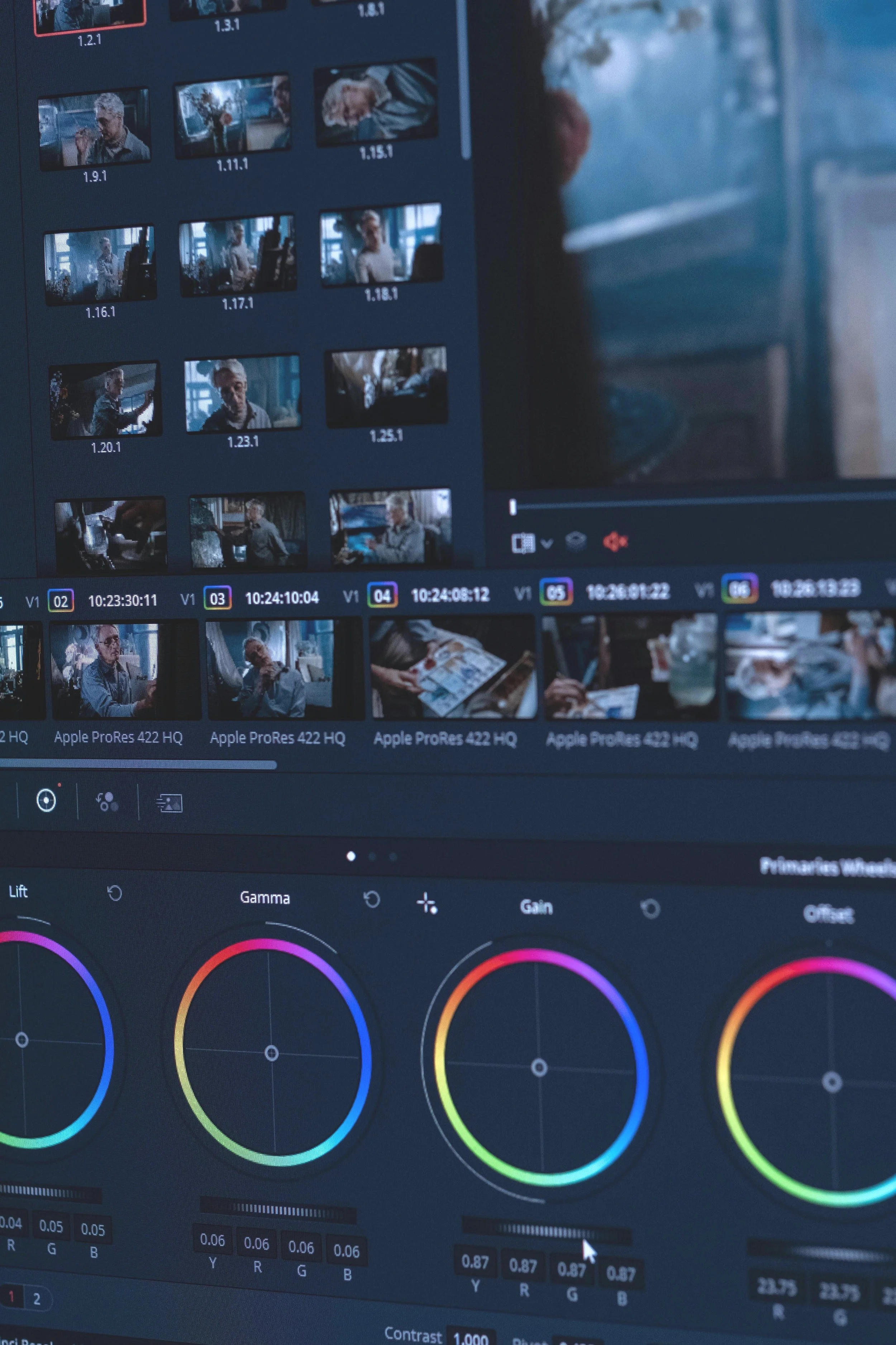 Computer screen displaying a video editing timeline with multiple video clips and color correction controls, including hue and saturation adjustment wheels.