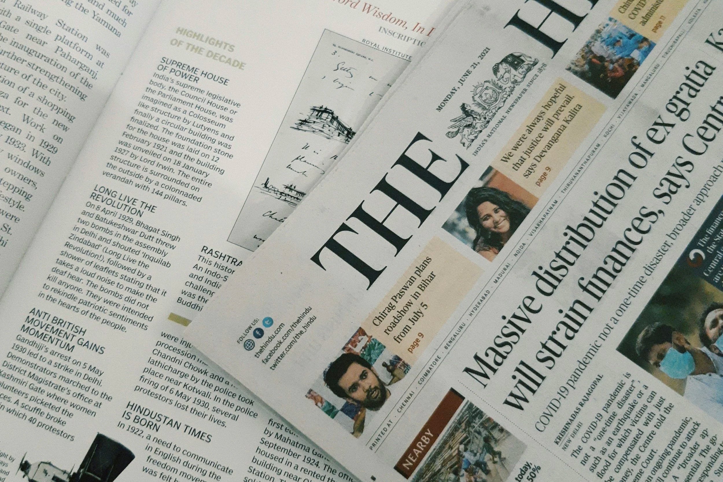 Stack of newspapers featuring various news headlines and stories