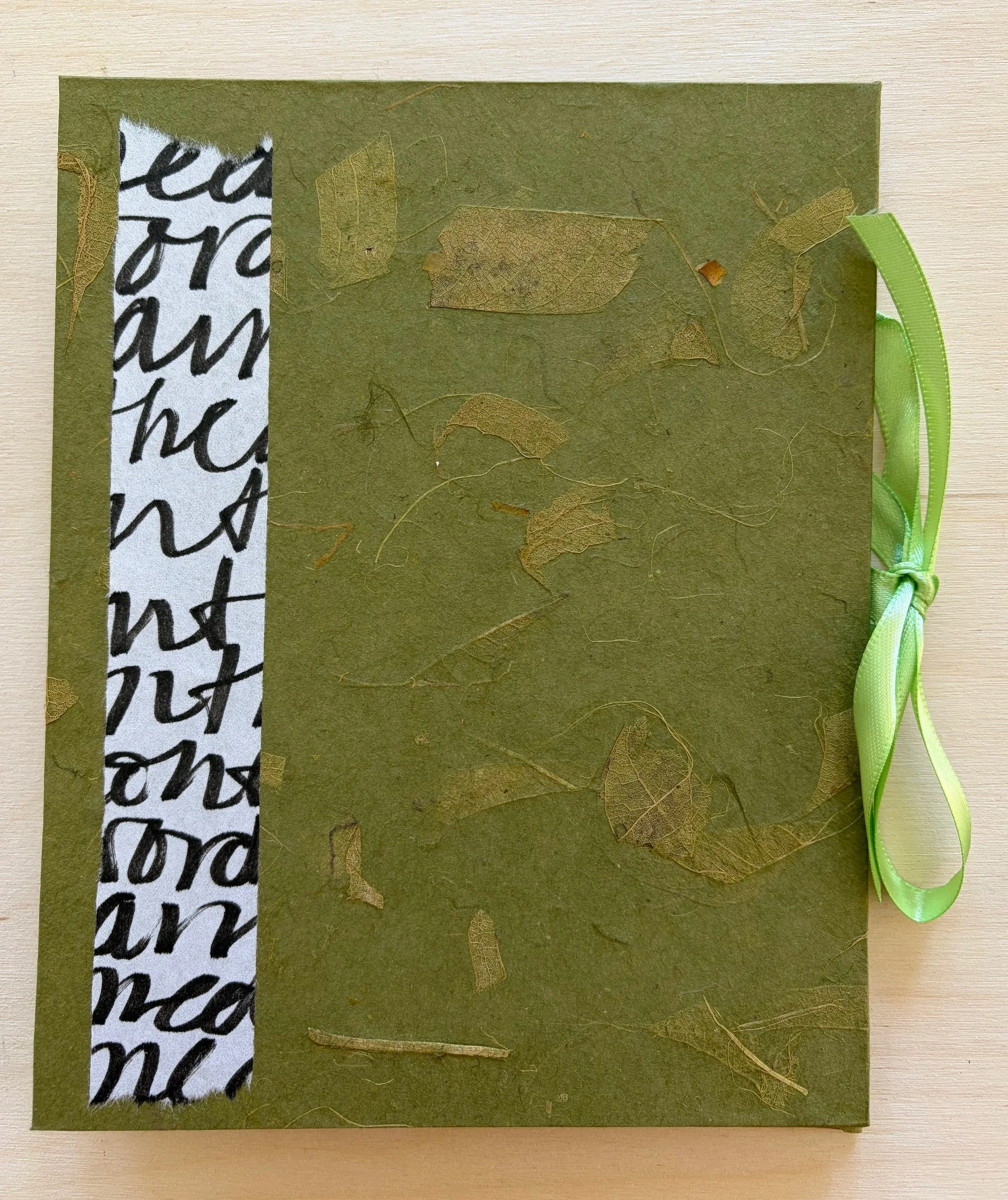 A simple folded book with mulberry cover and added text on hosho paper