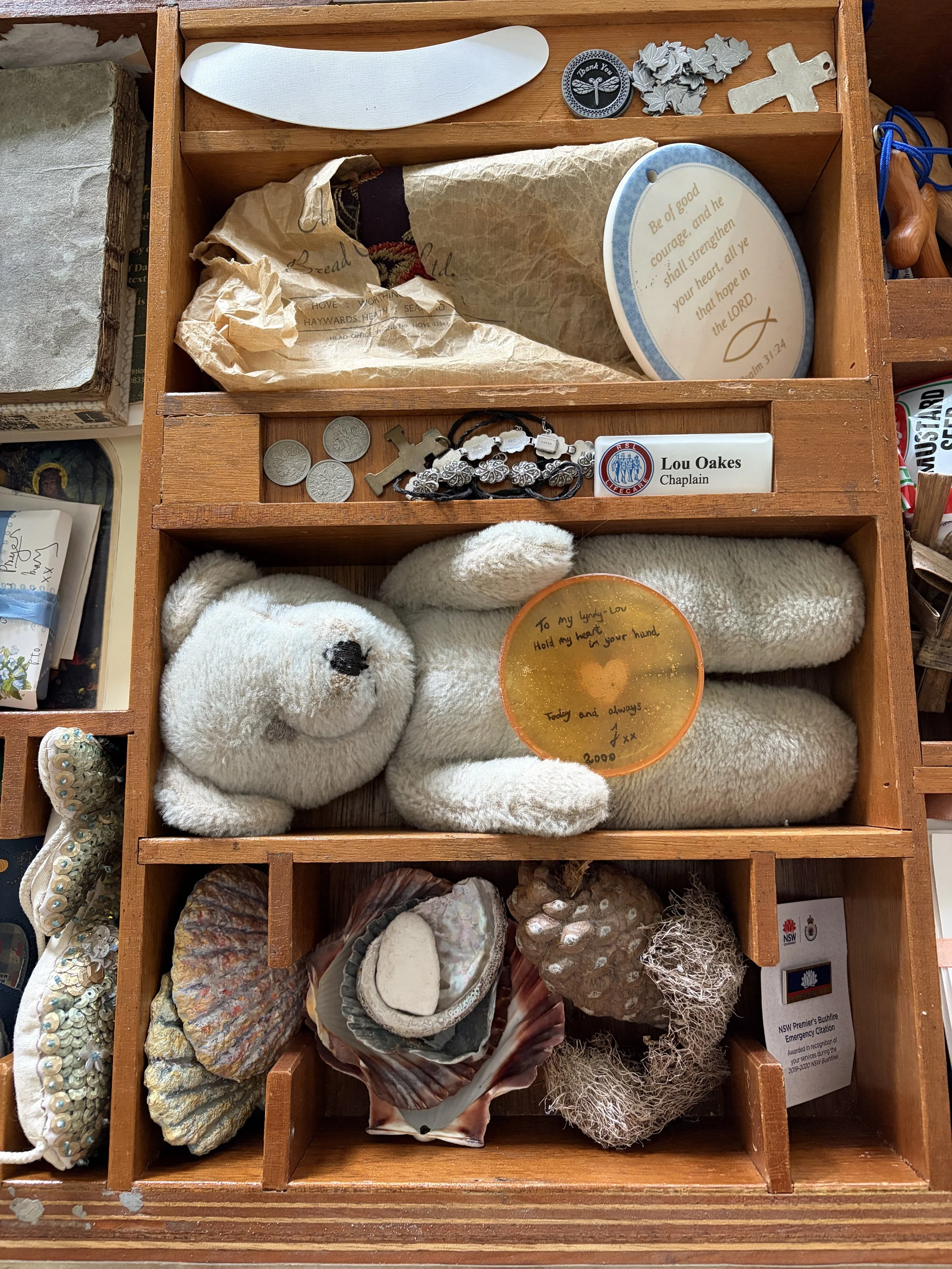 A Love Letter to My Younger Self
An old cigar display case holds a collection of treasured objects gathered across a lifetime—letters, childhood drawings, symbols of ministry and a first tin of watercolours. Together, they form a tender self-portrait