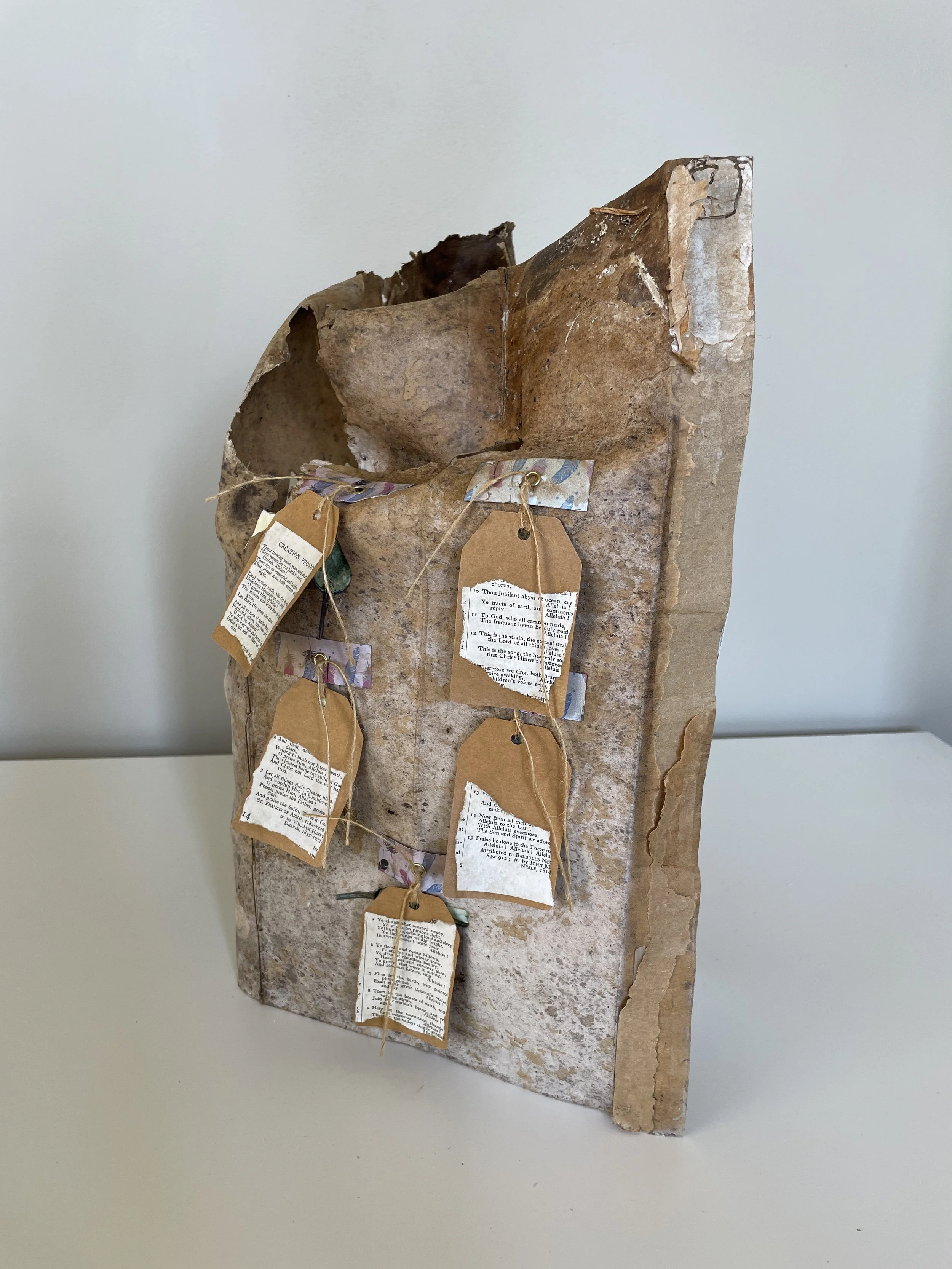 And the trees of the field shall clap their hands!  This work reimagines the tree as a vessel for memory, decay and reconstruction. Holding within its pages remembrance of wind and bark clapping with joy, its weathered, organic surfaces bear the mark