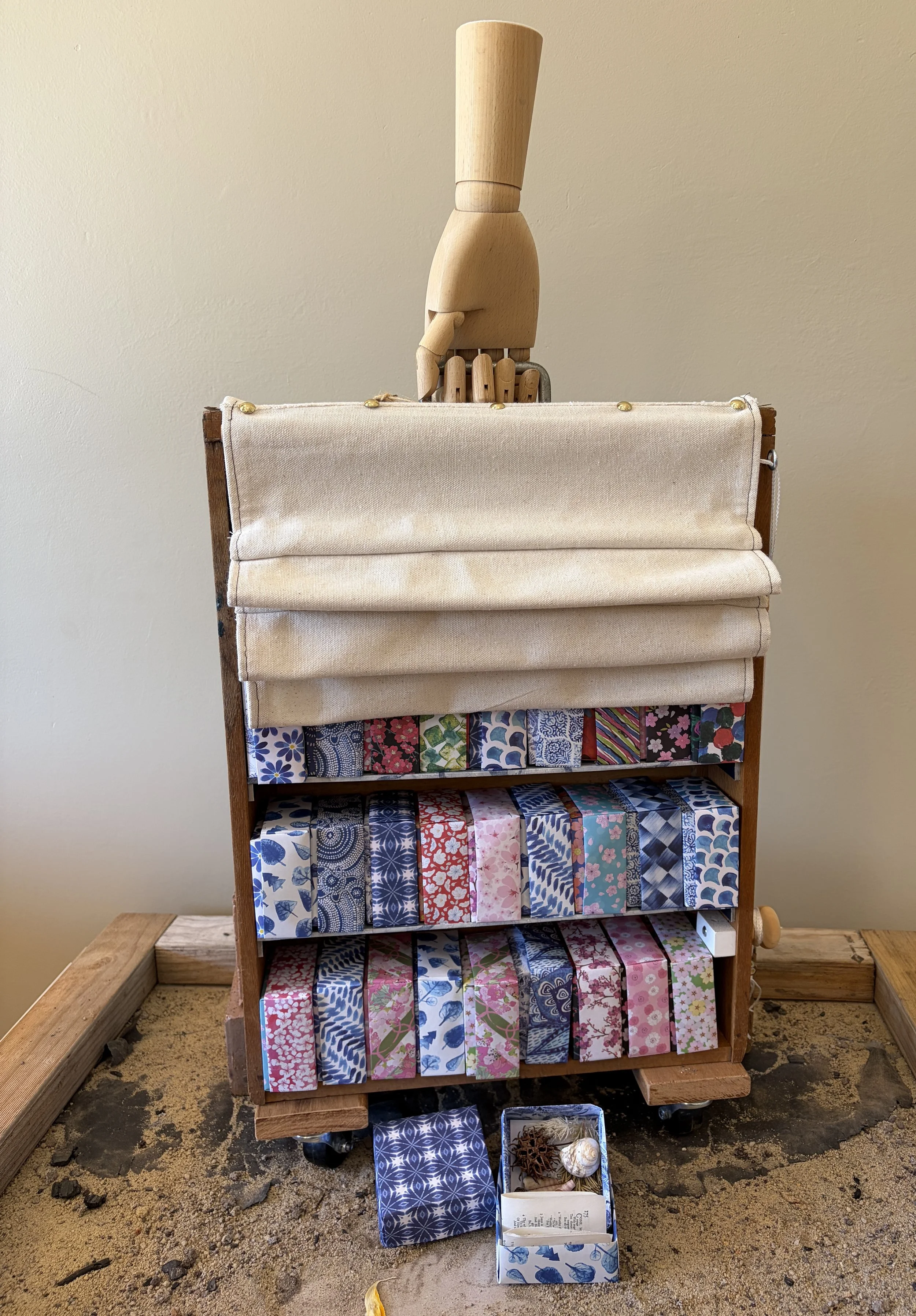 Wanted on voyage (travelling bookcase)
Bringing together found objects and feeling my way, I made a curious bookcase that is also a book.  The covers a repurposed drawer and a remnant of canvas; the shelves are the chapters; each box a sentence and t
