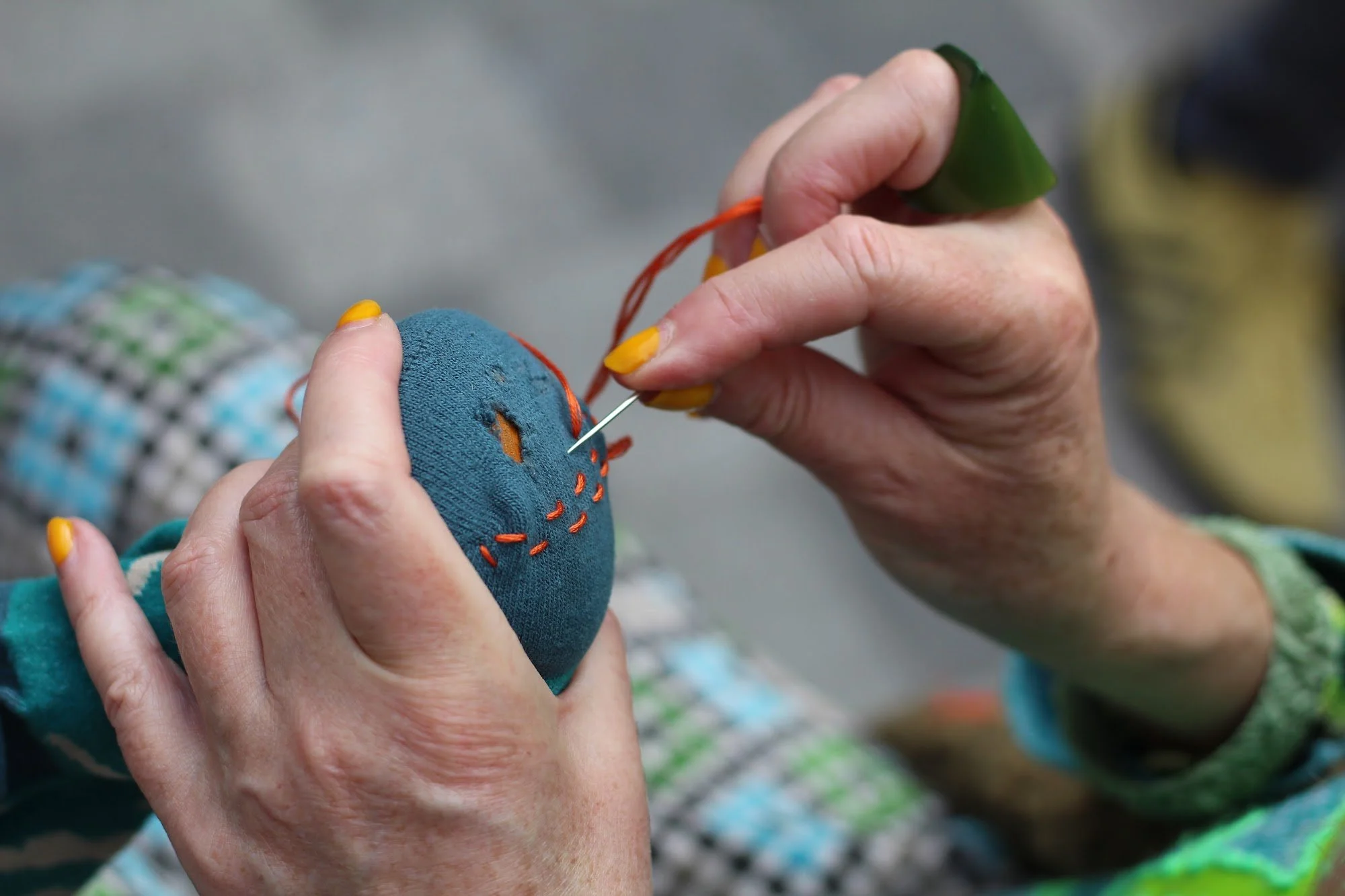 Hands mending. Credit: Liv Simpliciano