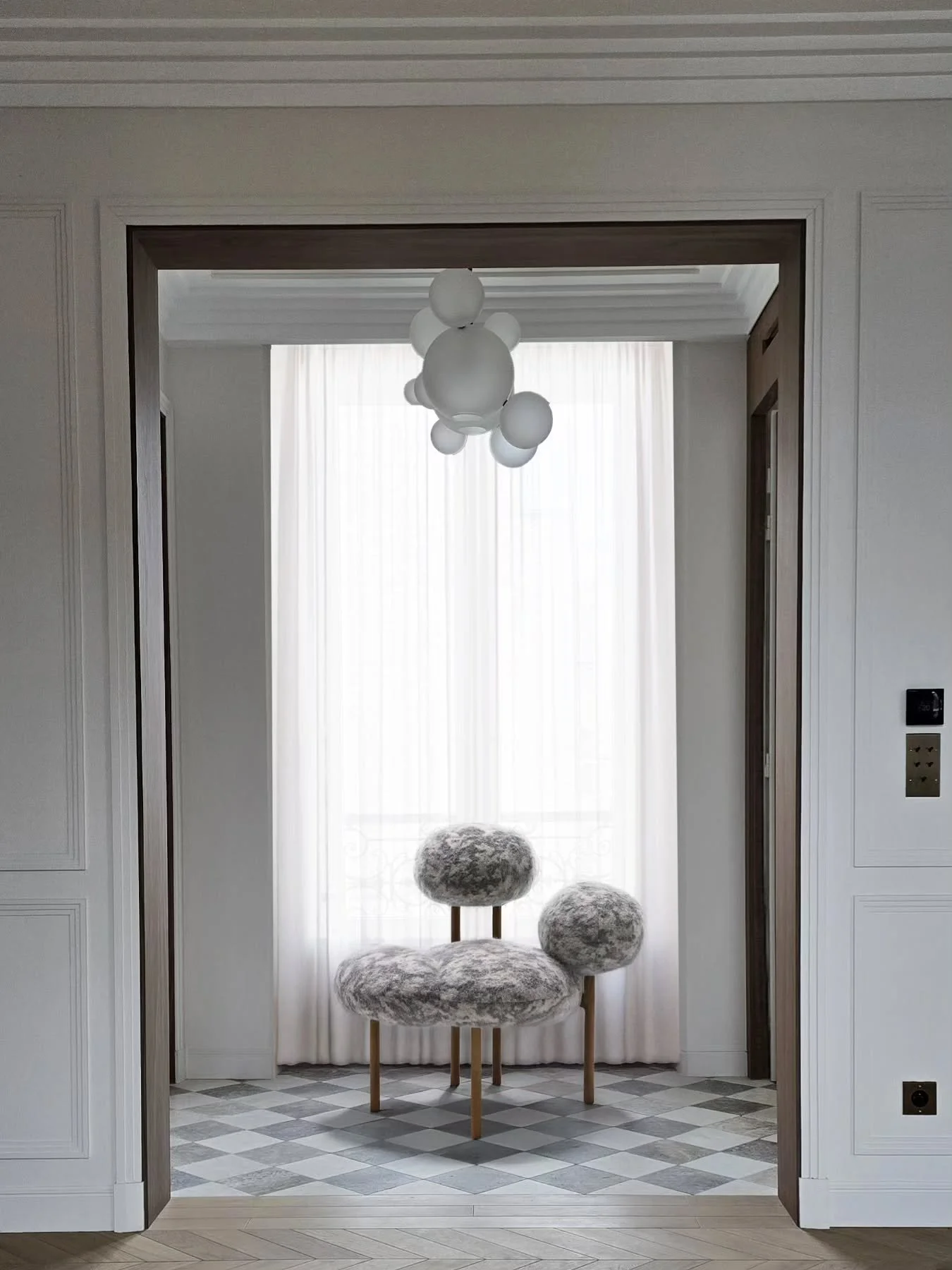 PROJET BATIGNOLLES 
A new perspective. This opening reshaped the apartment's architecture, unfolding a sequence of volumes in a muted ambience with soft light and material interplay. At the vanishing point, the Cumulus armchair anchors the view.
#in