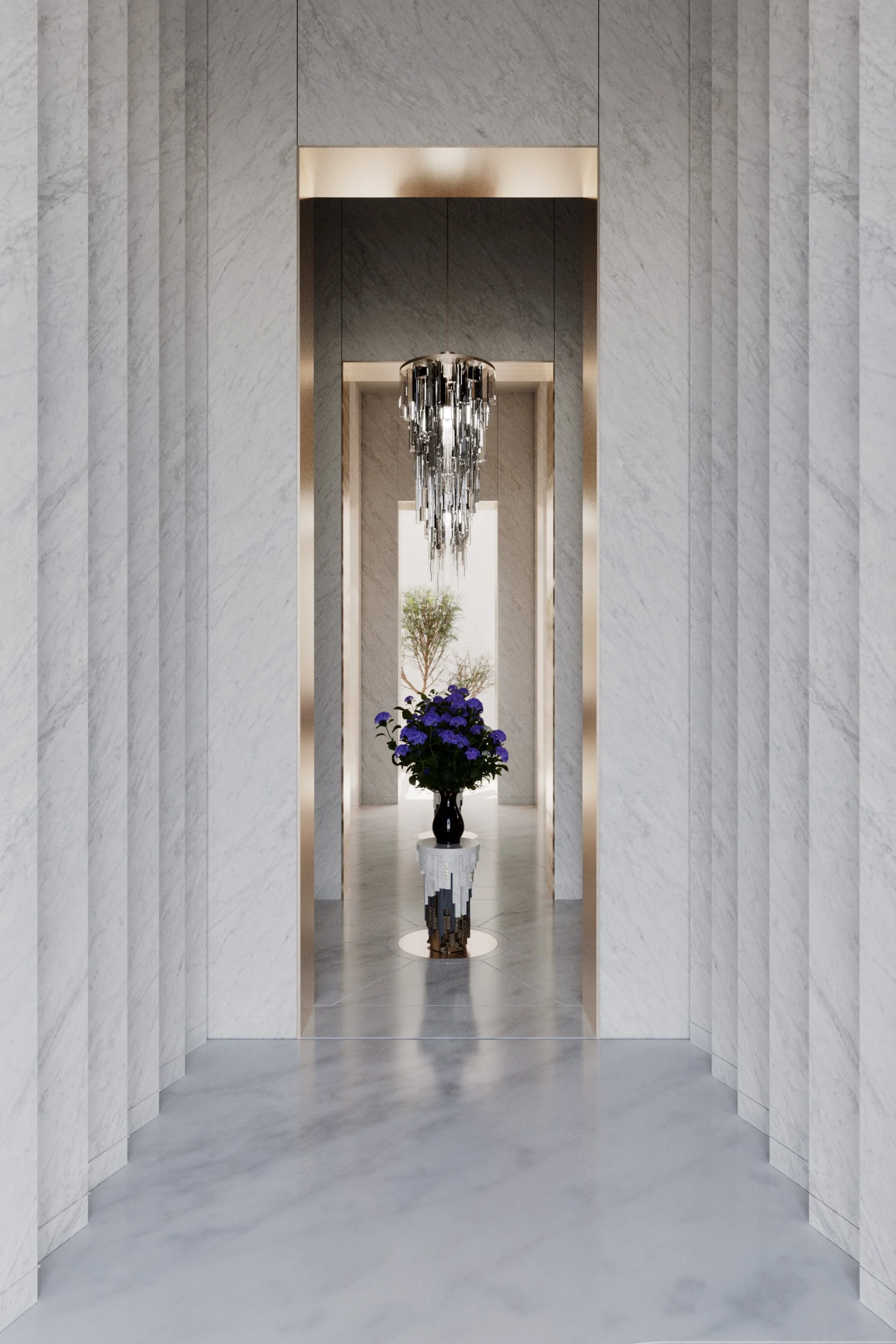 An elegant hallway with white marble walls, lit by a contemporary crystal chandelier suspended from the ceiling, with a black vase containing purple flowers on a mirrored stand in the center.
