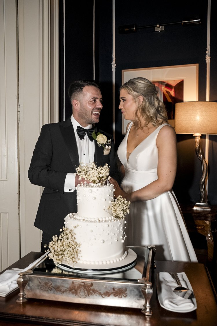 Bride and groom cutting their wedding cake