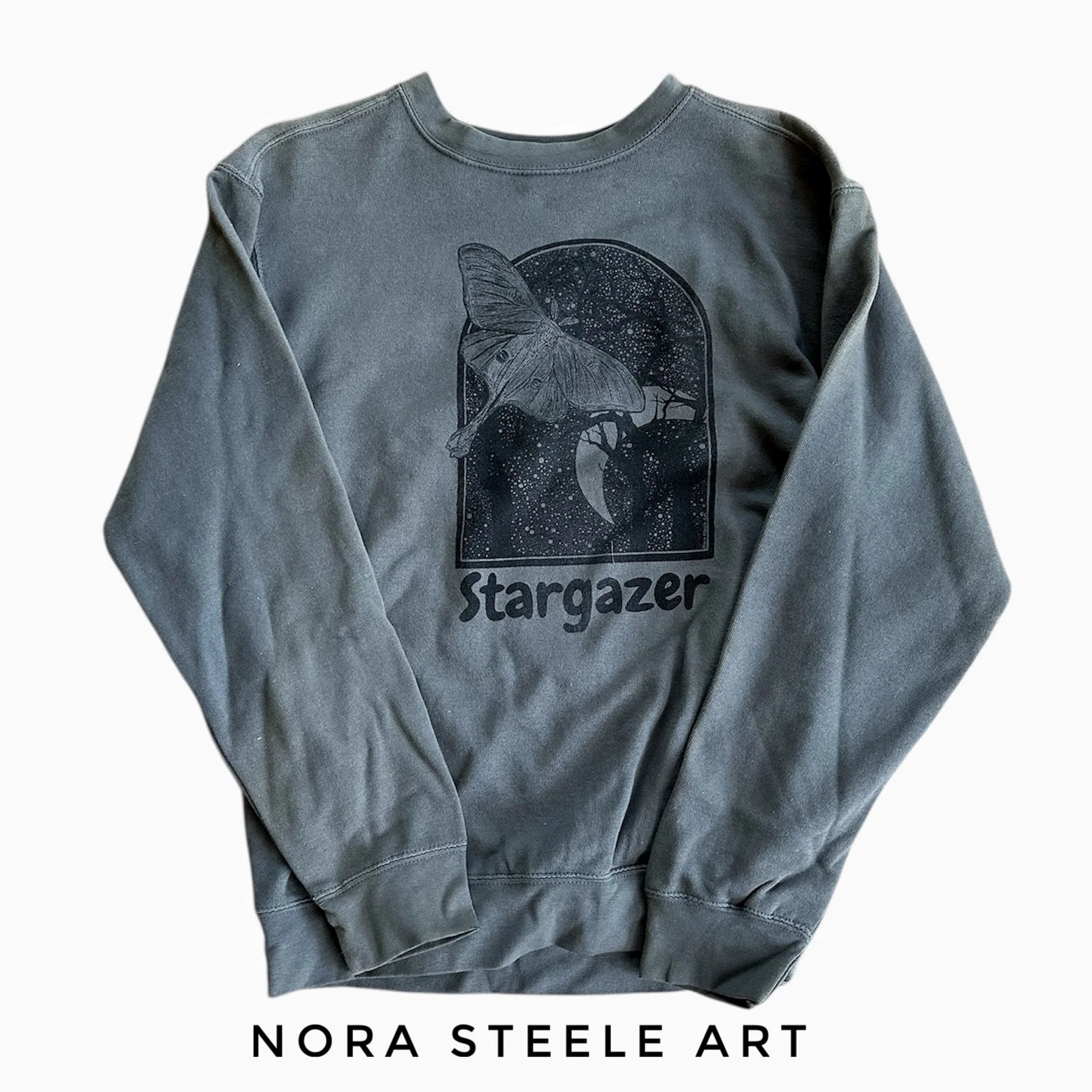 Sweatshirt screenprinted with a luna moth in a night sky with text saying "stargazer"
