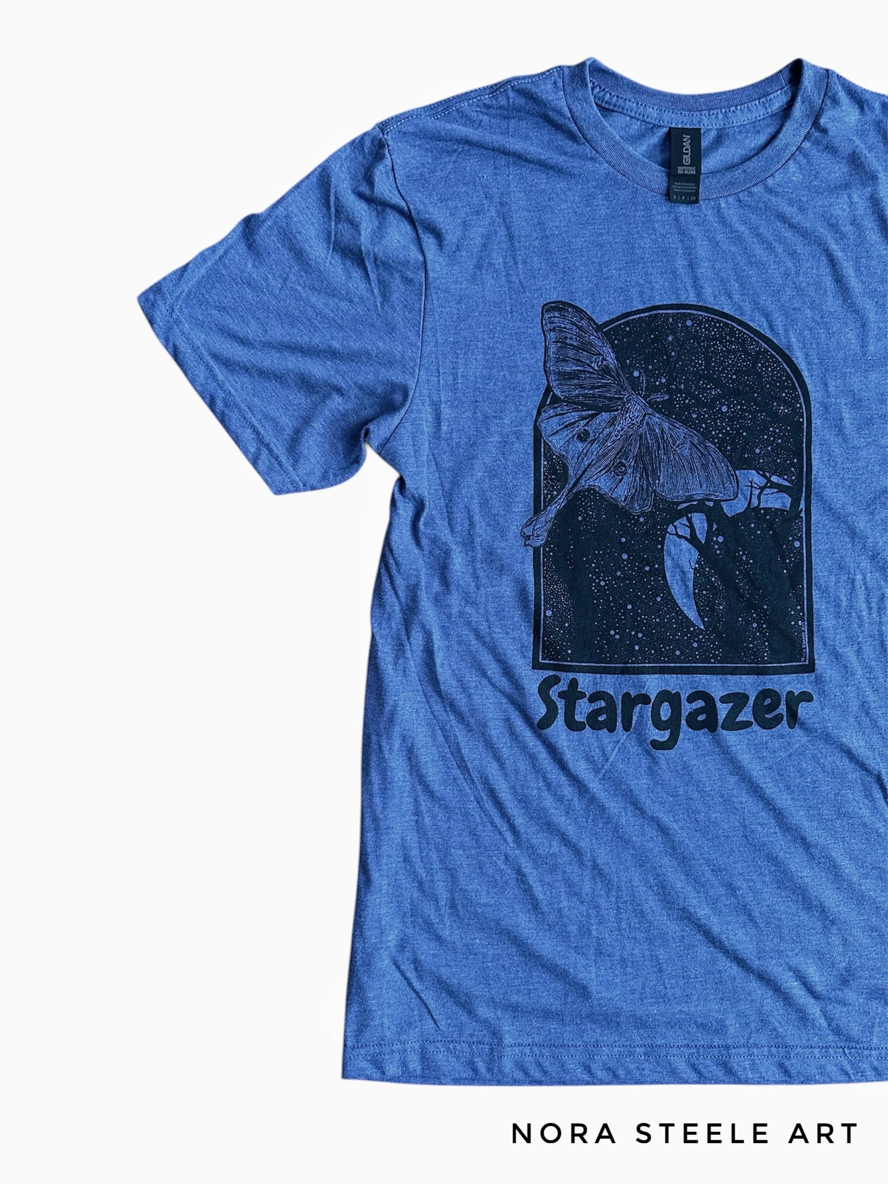 T-shirt screenprinted with a luna moth in a night sky with text saying "stargazer"