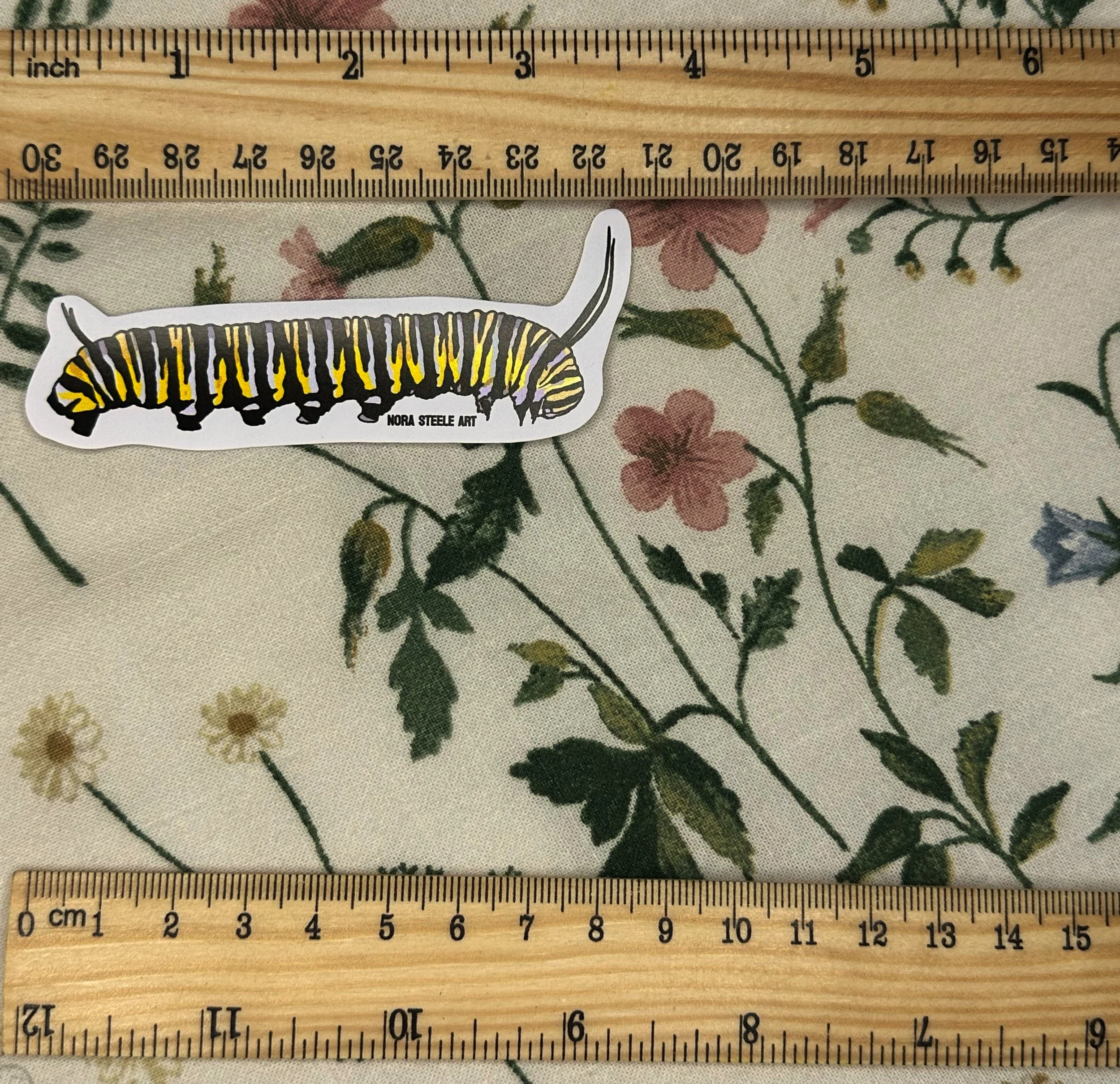 Monarch butterfly caterpillar sticker measuring about 3 1/2 inches long