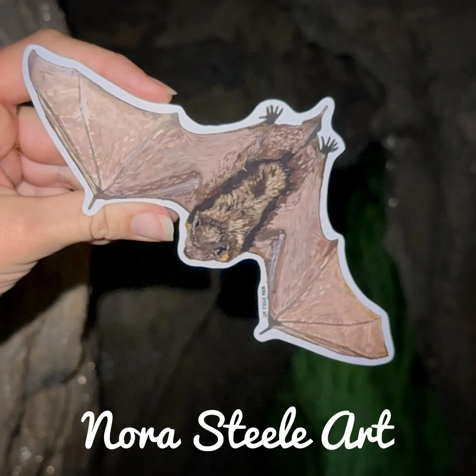 Little brown bat sticker flying in front of a tree at night