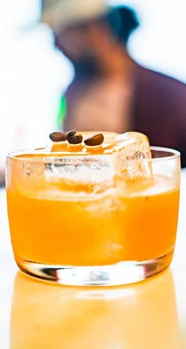 Orange cocktail with a dried citrus garnish at Marriott's Tales of the Cocktail pop-up