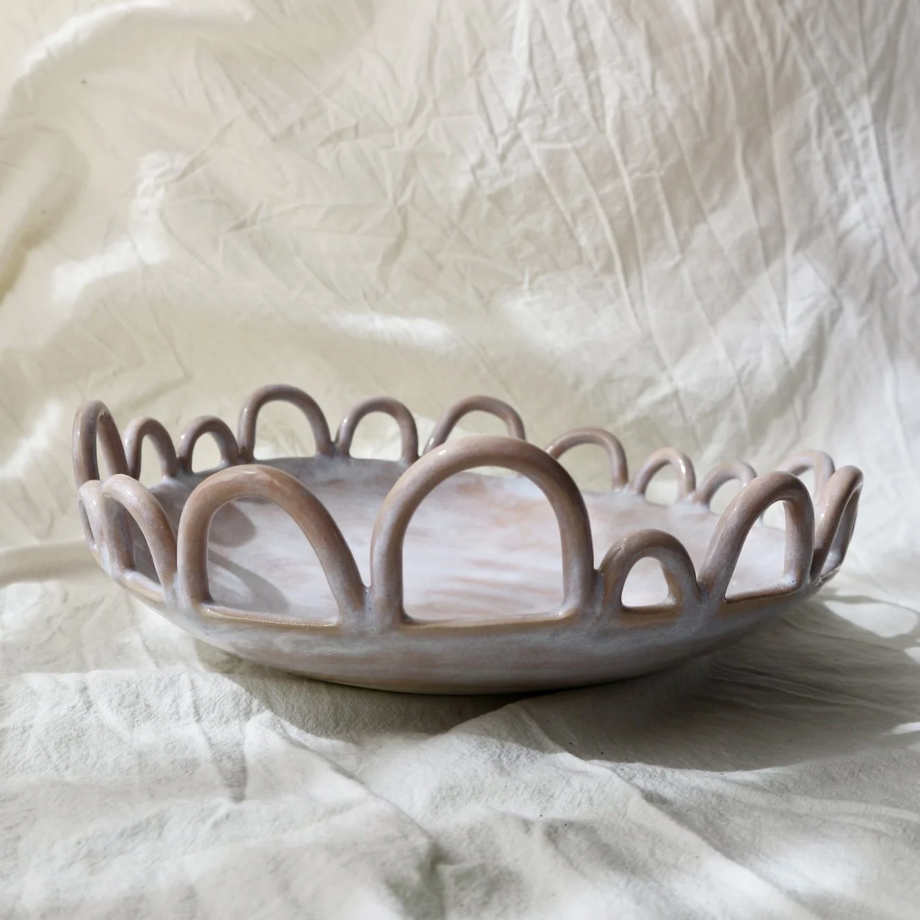 pink clay bowl on linen fabric