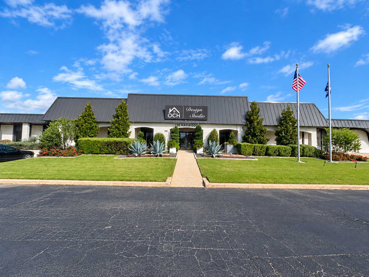 Exterior of commercial office building at 720 W. Harwood Road in Hurst, Texas, featuring landscaped grounds, a front entrance, and parking area.
