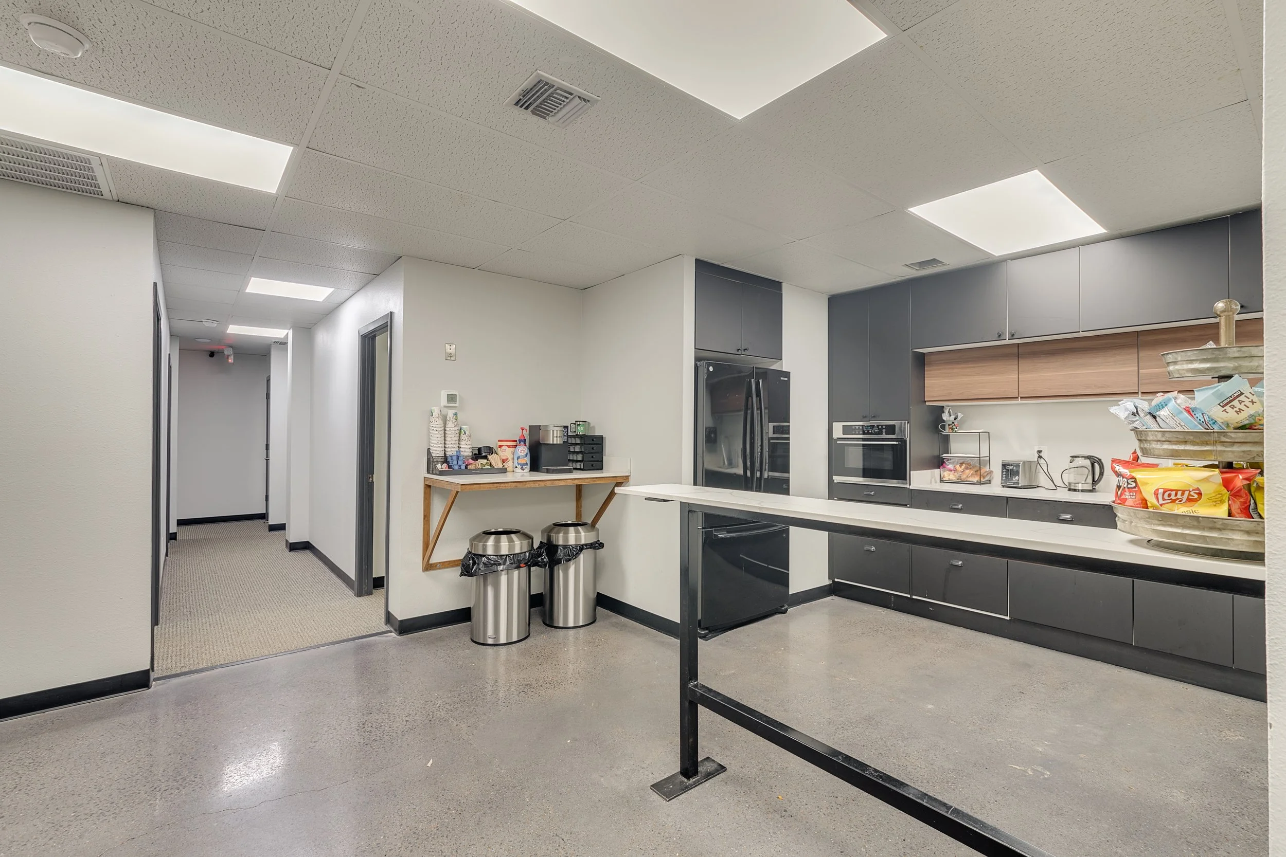 Shared office kitchenette with countertops, cabinets, and seating at 4925 Davis Boulevard in North Richland Hills, Texas.