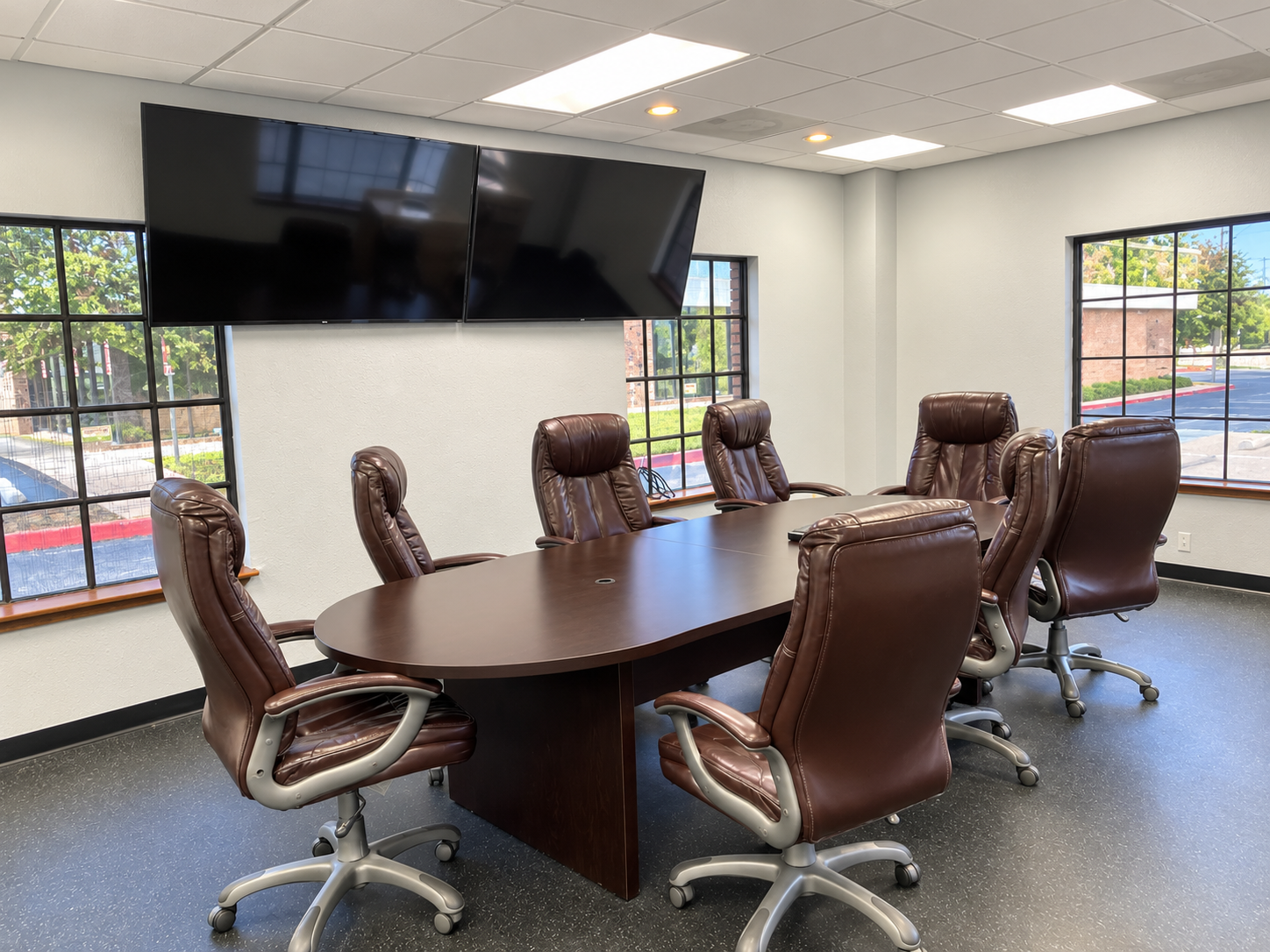 Professional conference room with a large meeting table, office chairs, and windows at 6401 Brentwood Stair Road in Fort Worth, Texas.