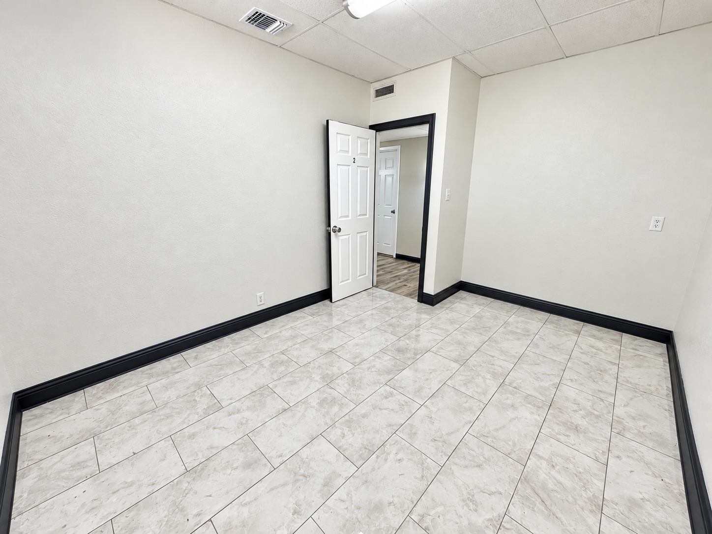 Unfurnished private office with light-colored tile flooring, white walls, and overhead lighting at 112 W. Pipeline Road in Hurst, Texas.