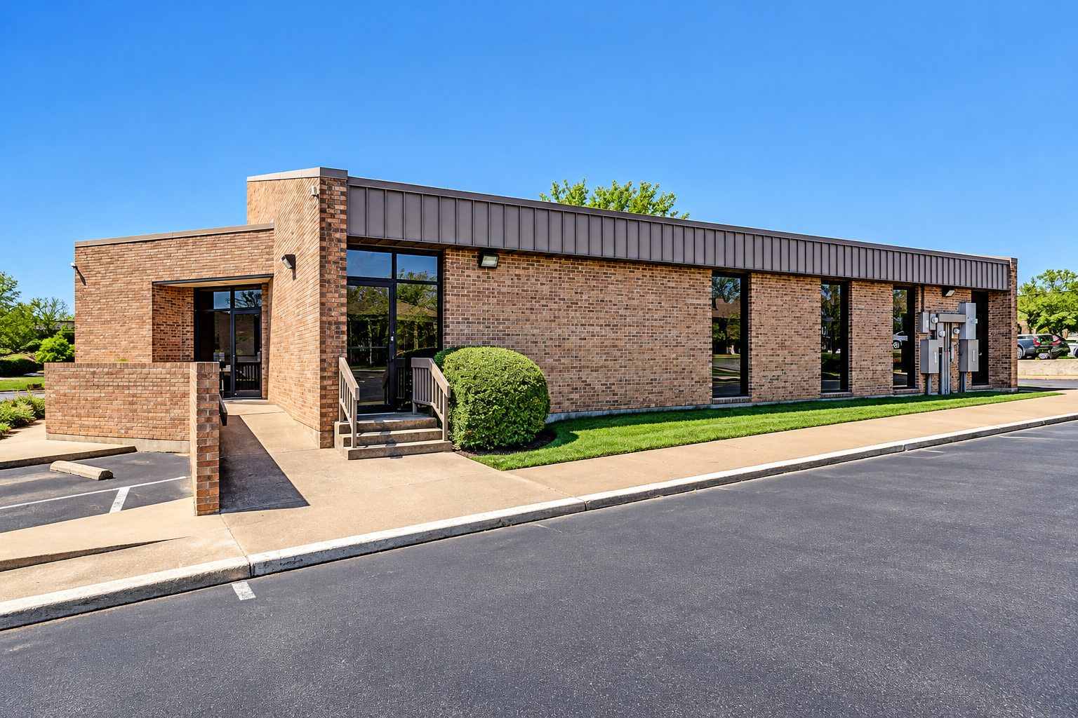 Exterior of the commercial office building at 425 Westpark Way in Euless, Texas, featuring a brick facade, glass entrance, and parking area.