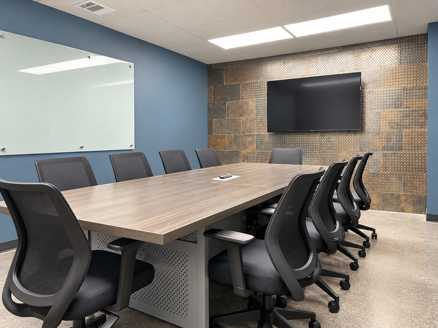 Professional conference room with a large meeting table, black office chairs, and wall-mounted television at 4925 Davis Boulevard in North Richland Hills, Texas.
