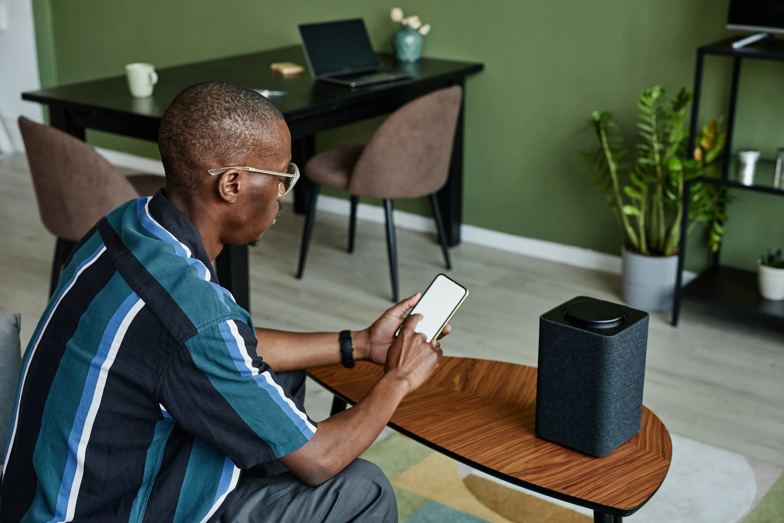 black-man-using-smart-speaker-at-home-2022-03-09-03-01-44-utc.jpg