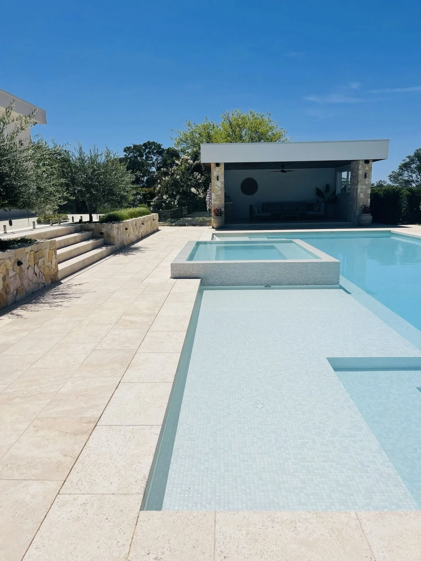 The brief: luxury without feeling overdone.
The result: a refined outdoor space where every detail works together, from stone walls to the elevated spa and pool house beyond. 

Pool and outdoor living designed by @fluidlandscapedesign
Pool constructi