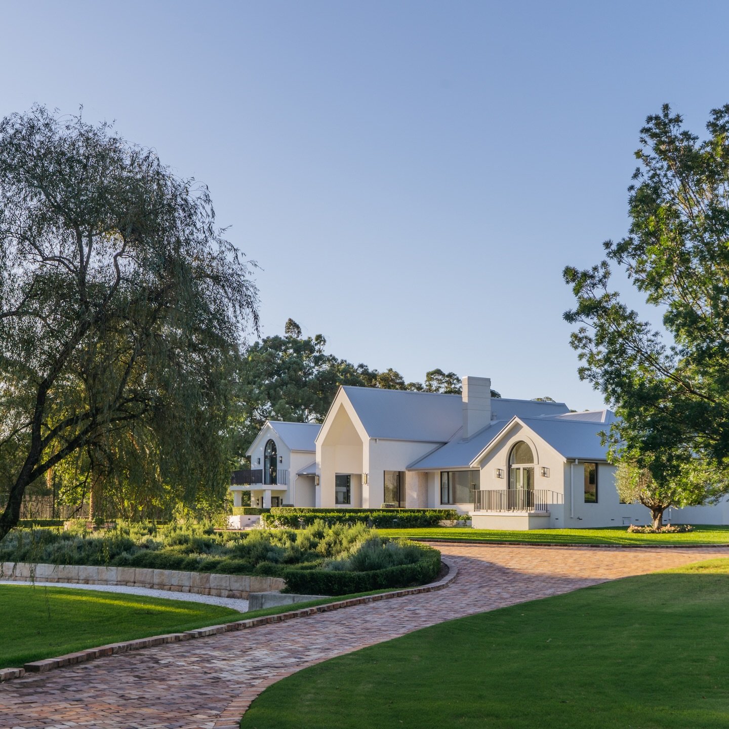 This acreage retreat on the western fringe of Sydney was designed for effortless outdoor living, where every angle feels calm, refined and timeless.

Including an infinity edge pool for uninterrupted views, olive grove pathways and layered spaces to 
