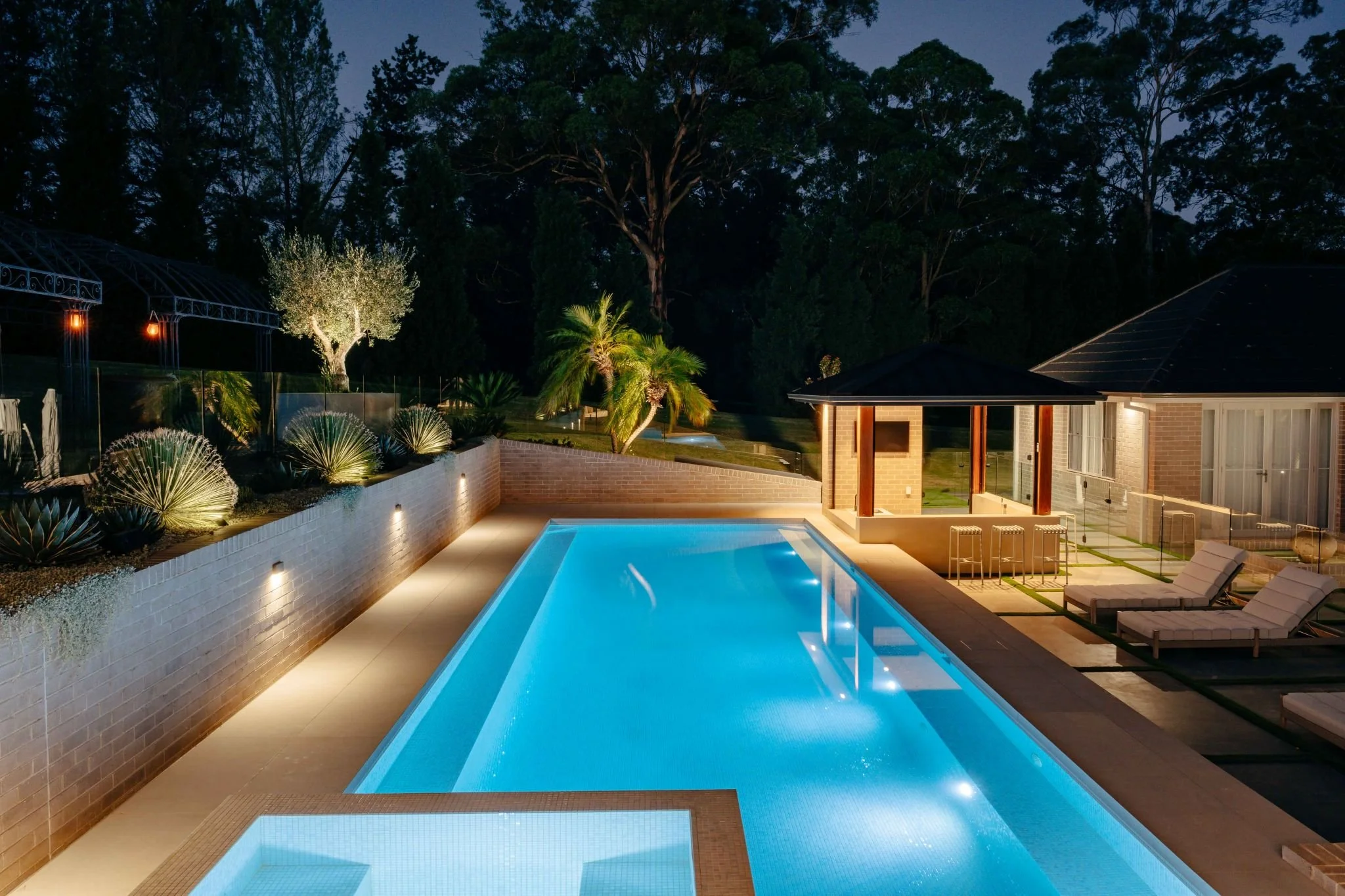 Pool and integrated spa at night