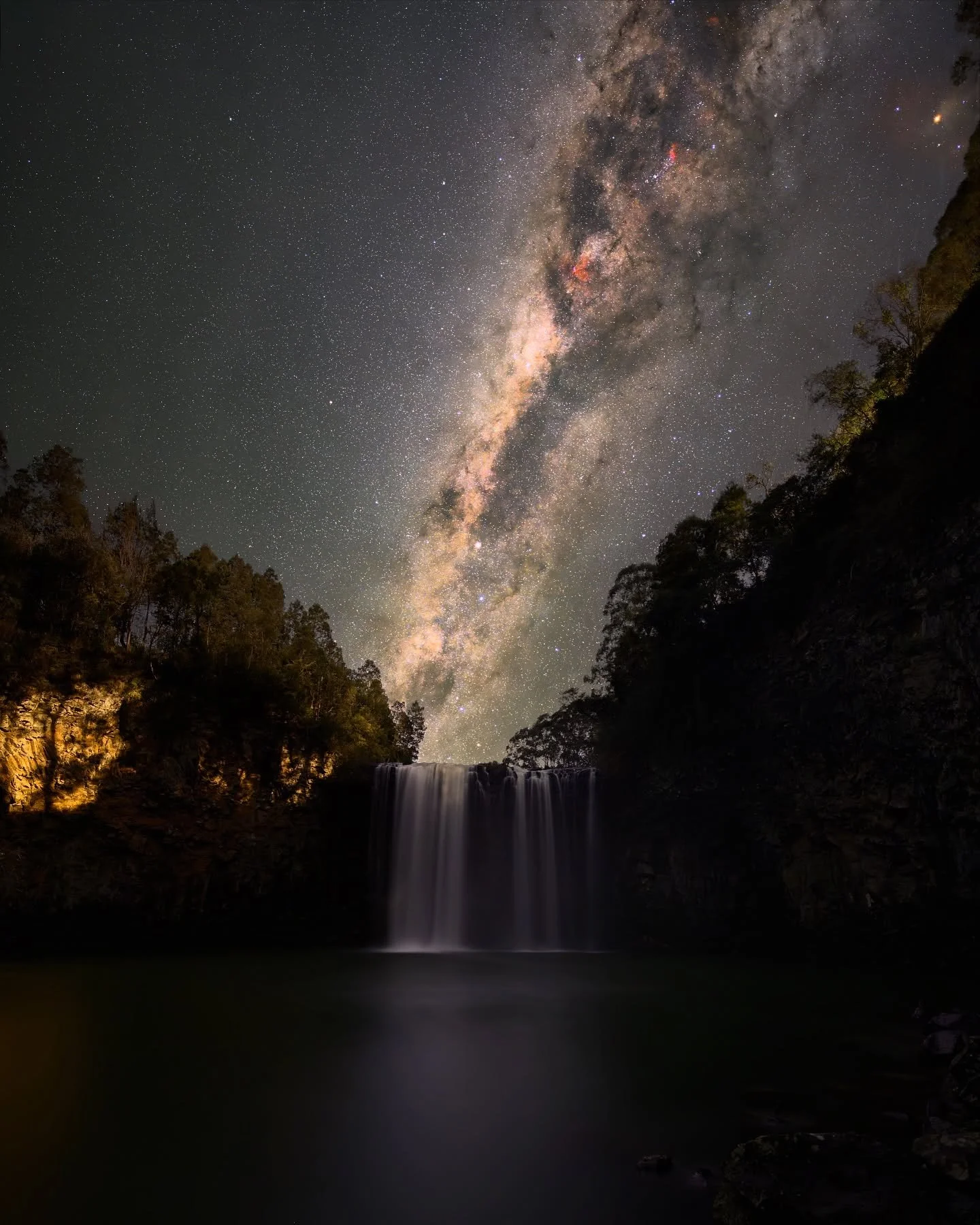 The verse 「飞流直下三千尺,疑似银河落九天」 was written by a Chinese poet in the 8th century. Its meaning is that the waterfall, like a mighty river, plunges straight down from the towering mountain, stretching three thousand feet, making one wonder whether it is th