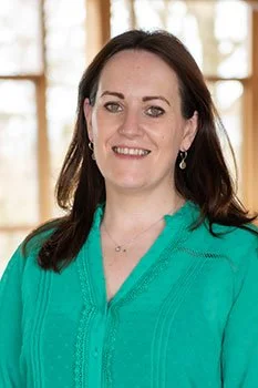 Woman in a green blouse smiling