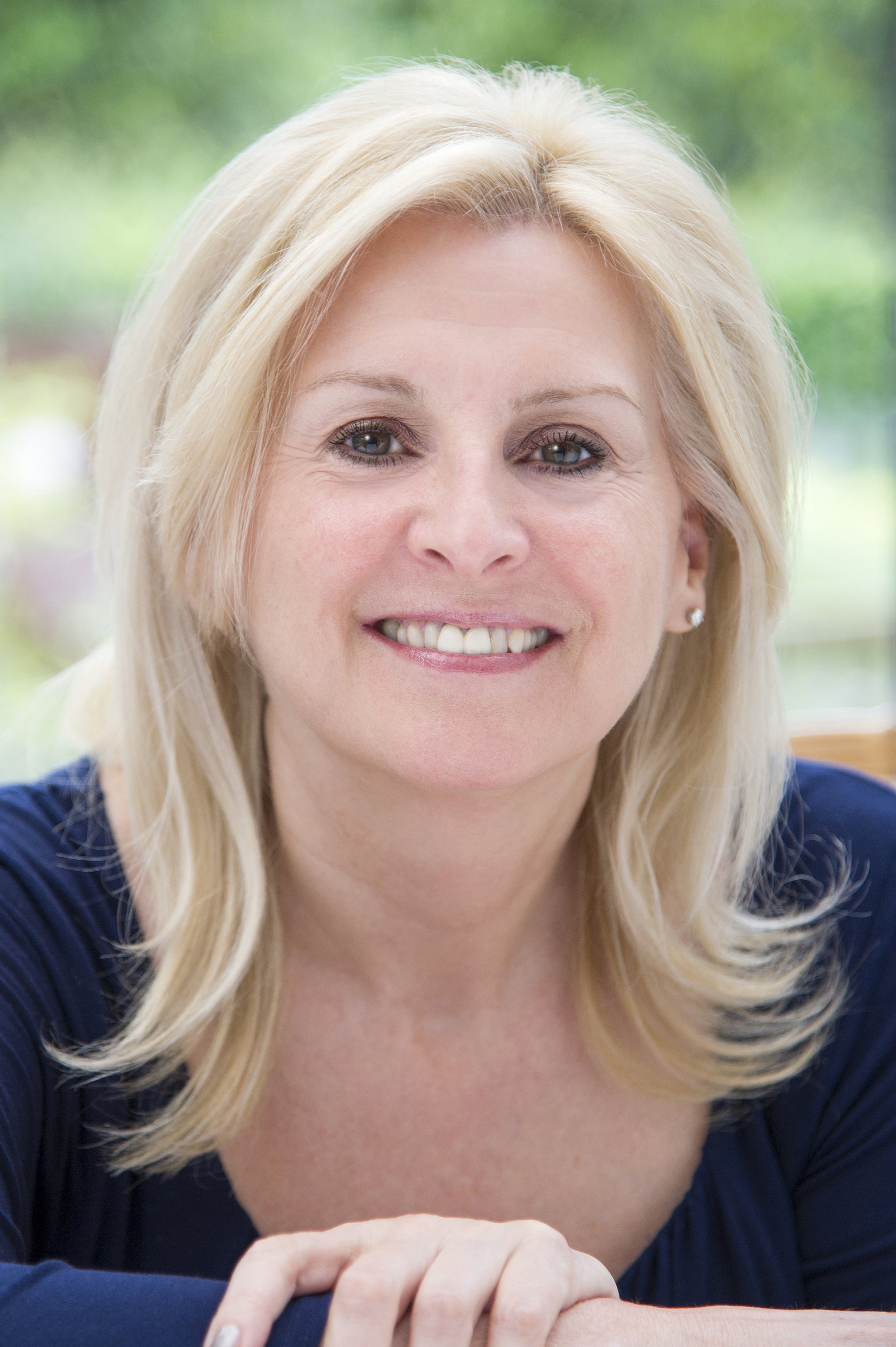 Business headshot photography female smiling at camera.