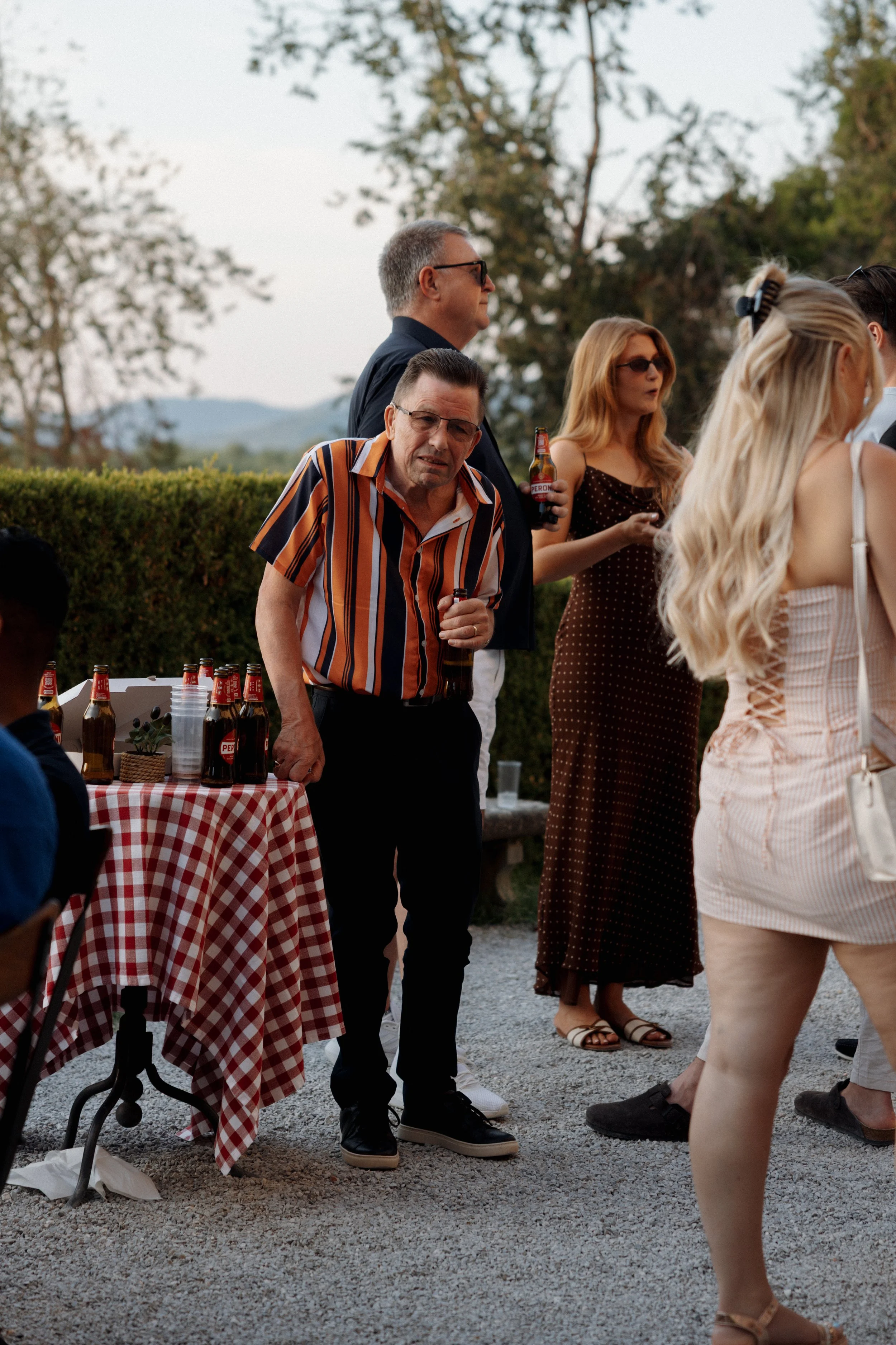 Bride and guests enjoying a pizza welcome party at Borgo di Pietrafitta in Tuscany, Italy