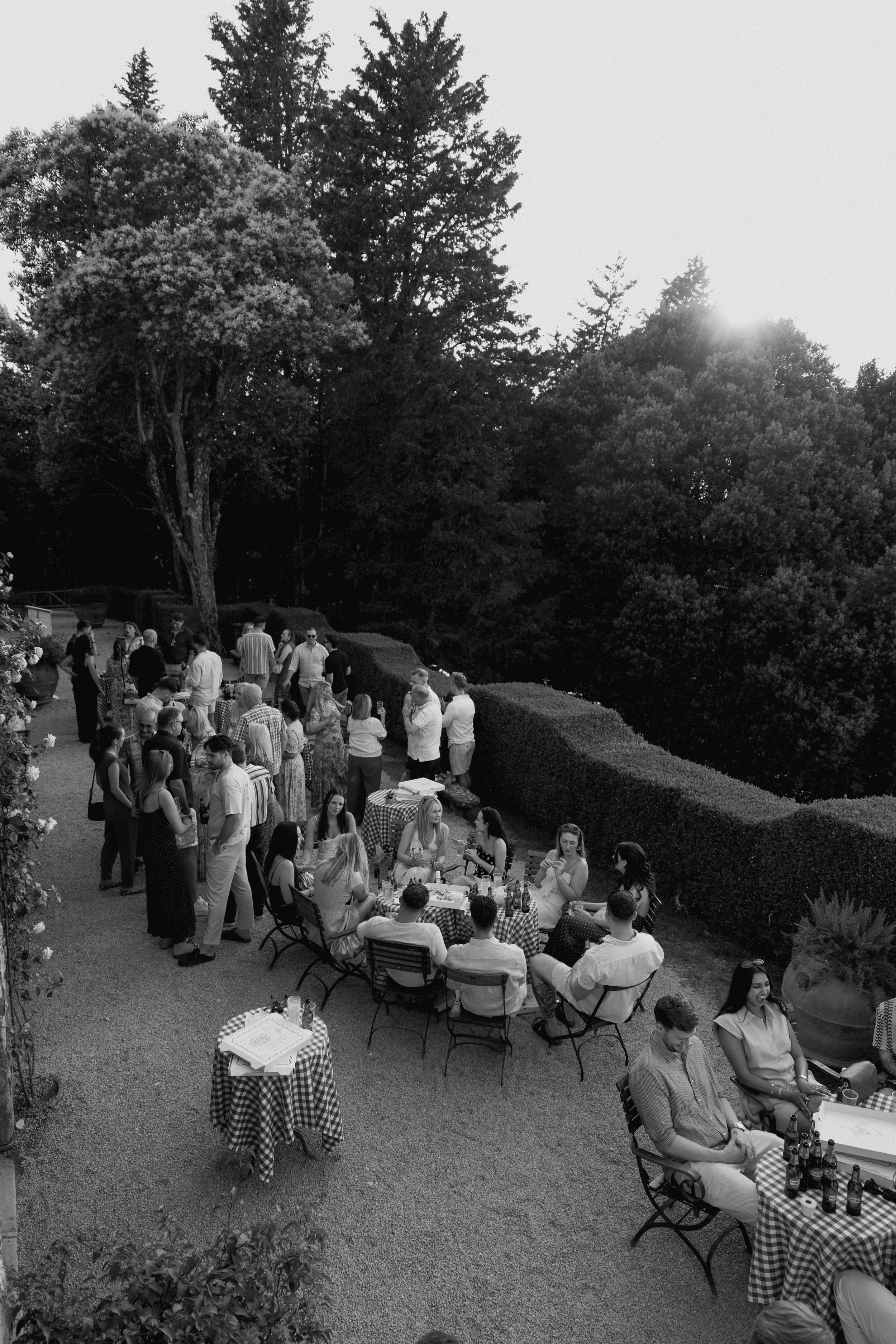 Bride and guests enjoying a pizza welcome party at Borgo di Pietrafitta in Tuscany, Italy