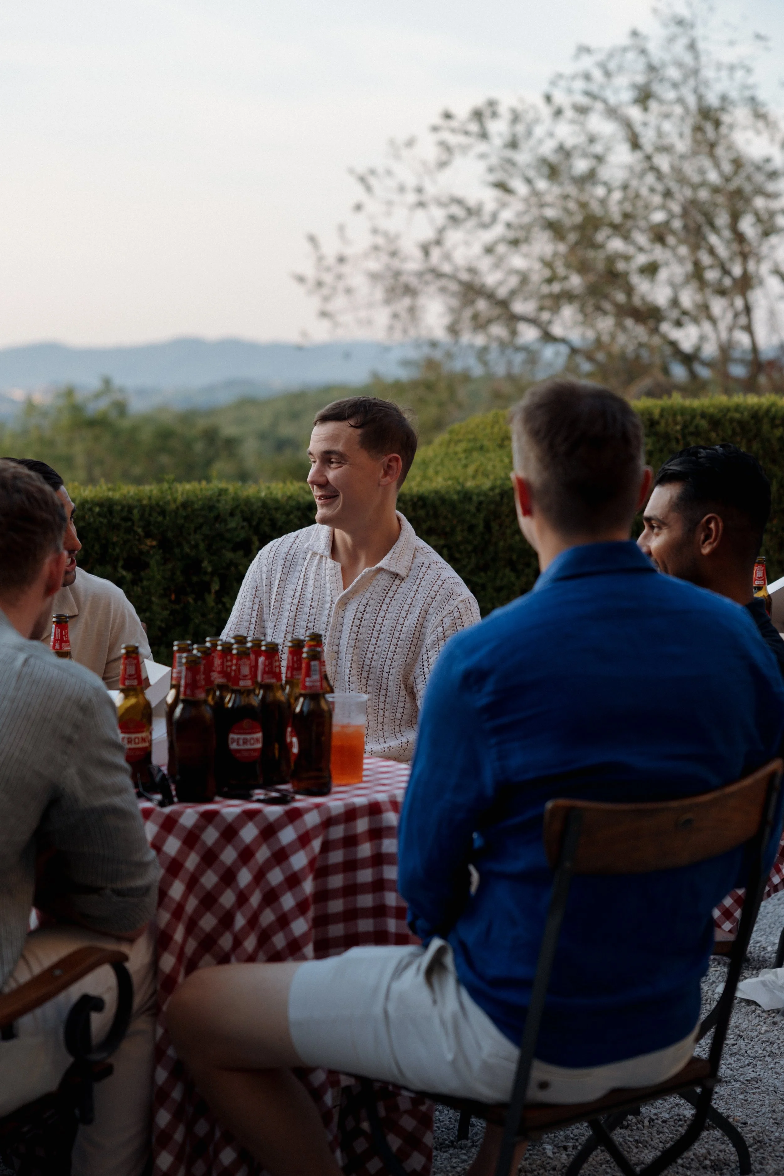 Bride and guests enjoying a pizza welcome party at Borgo di Pietrafitta in Tuscany, Italy