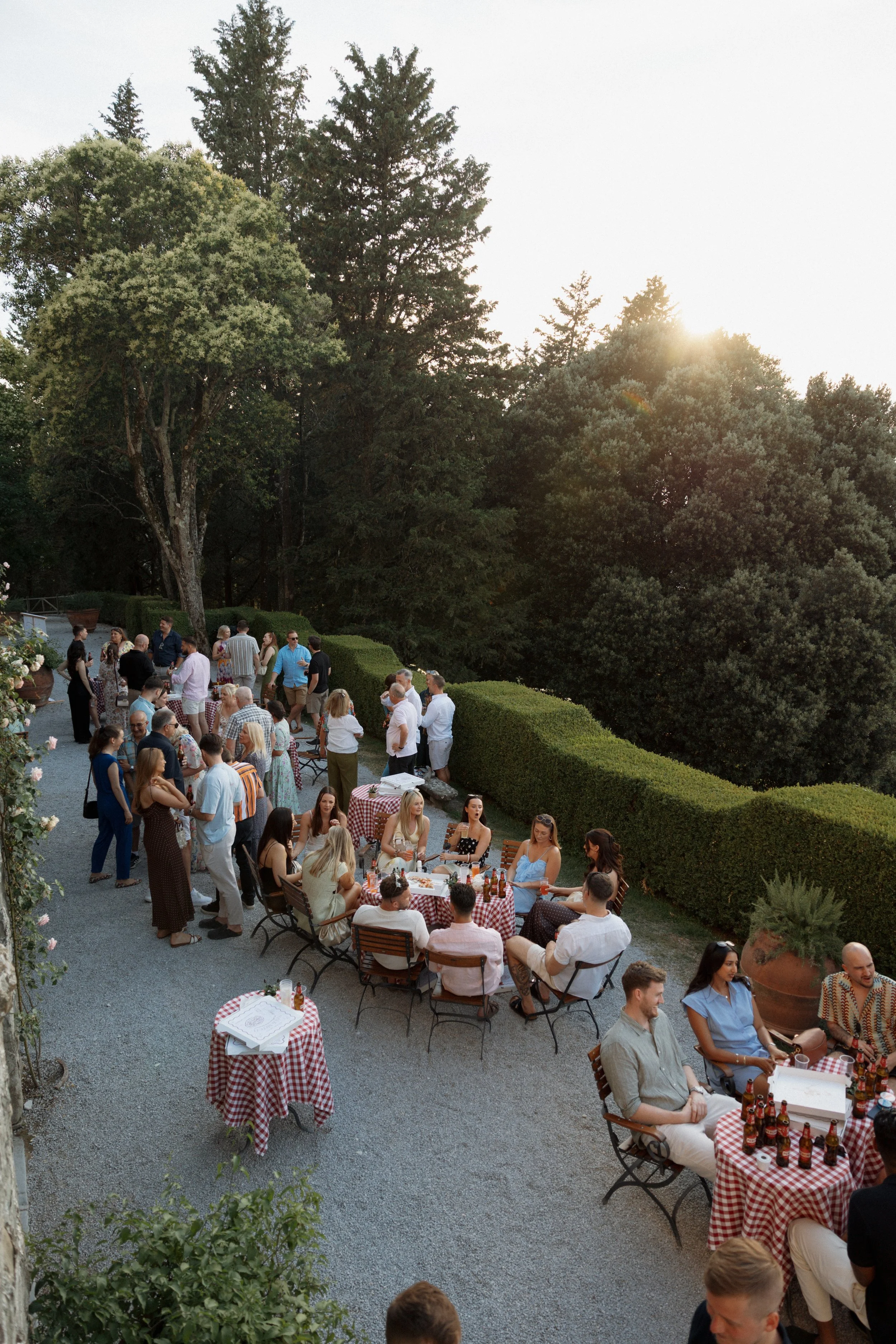 Bride and guests enjoying a pizza welcome party at Borgo di Pietrafitta in Tuscany, Italy