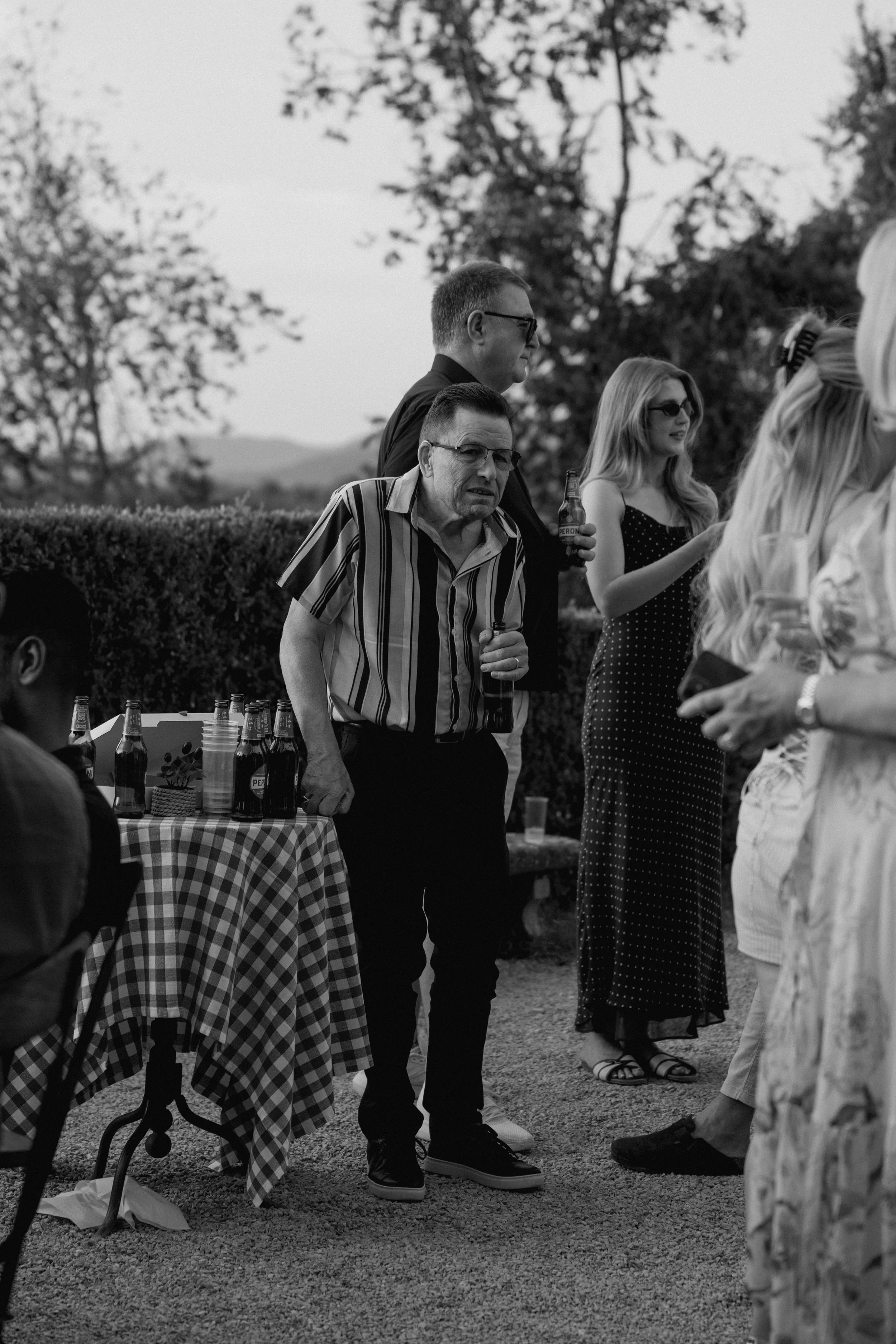 Bride and guests enjoying a pizza welcome party at Borgo di Pietrafitta in Tuscany, Italy