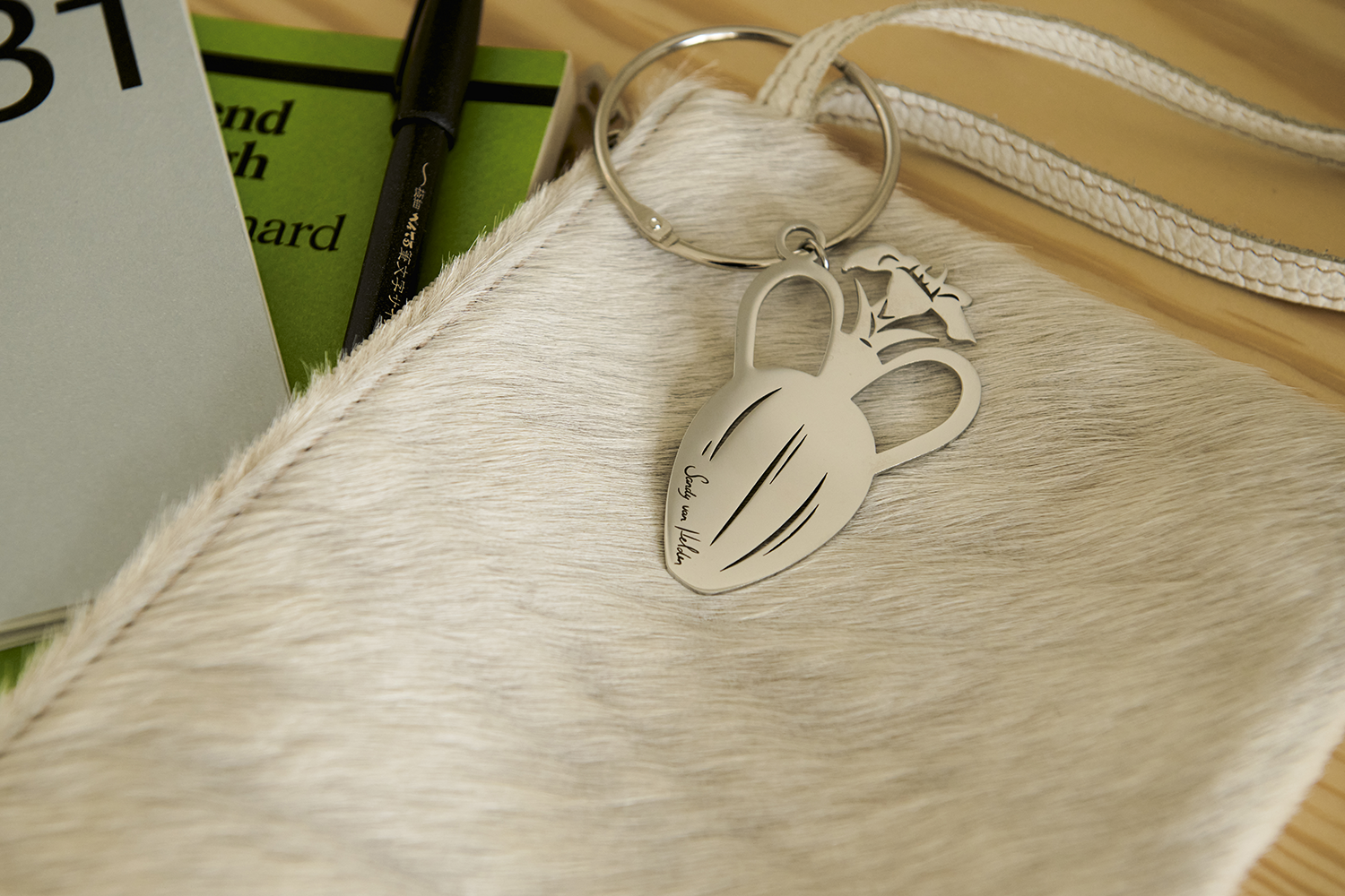 Charming No.1 illustrated stainless steel bag charm on clutch