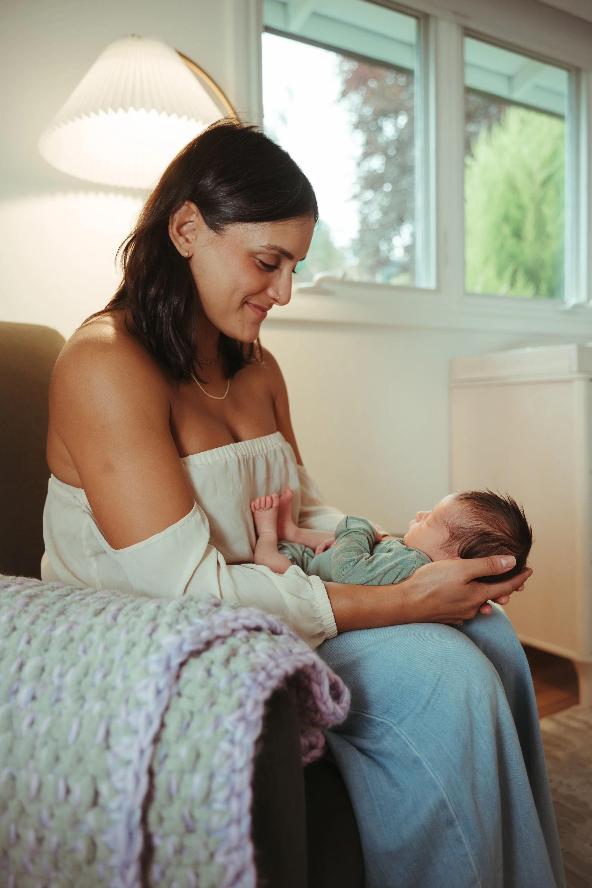mother finishes breastfeeding her newborn