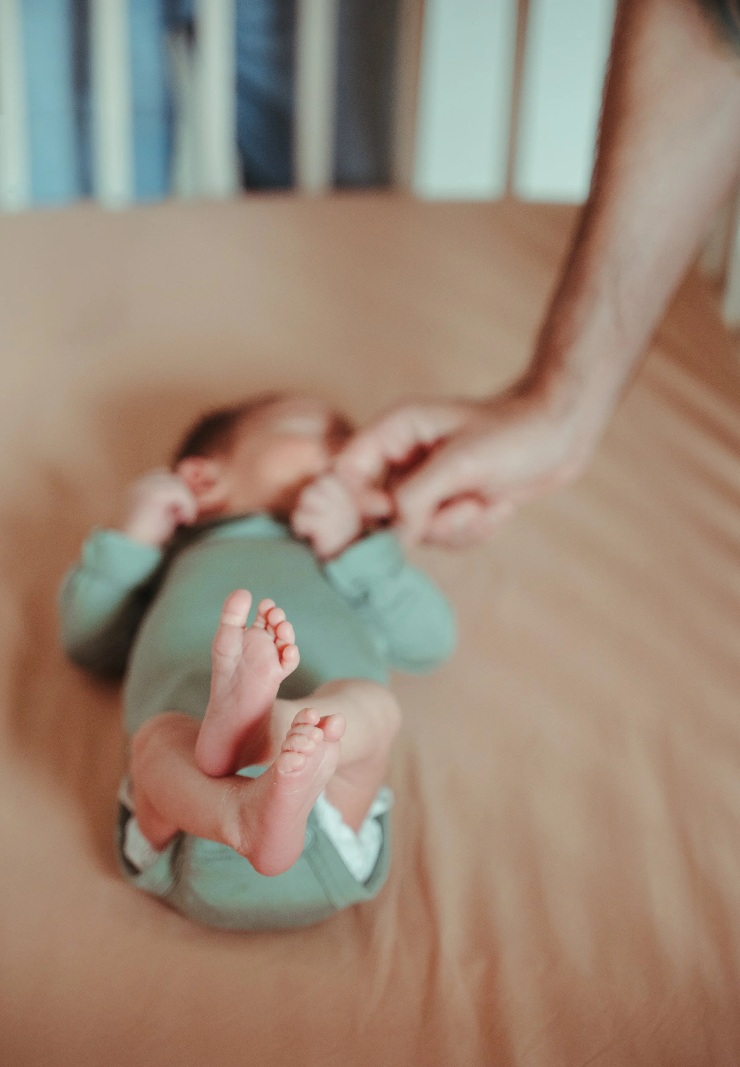 Newborn baby falling asleep in bassinet