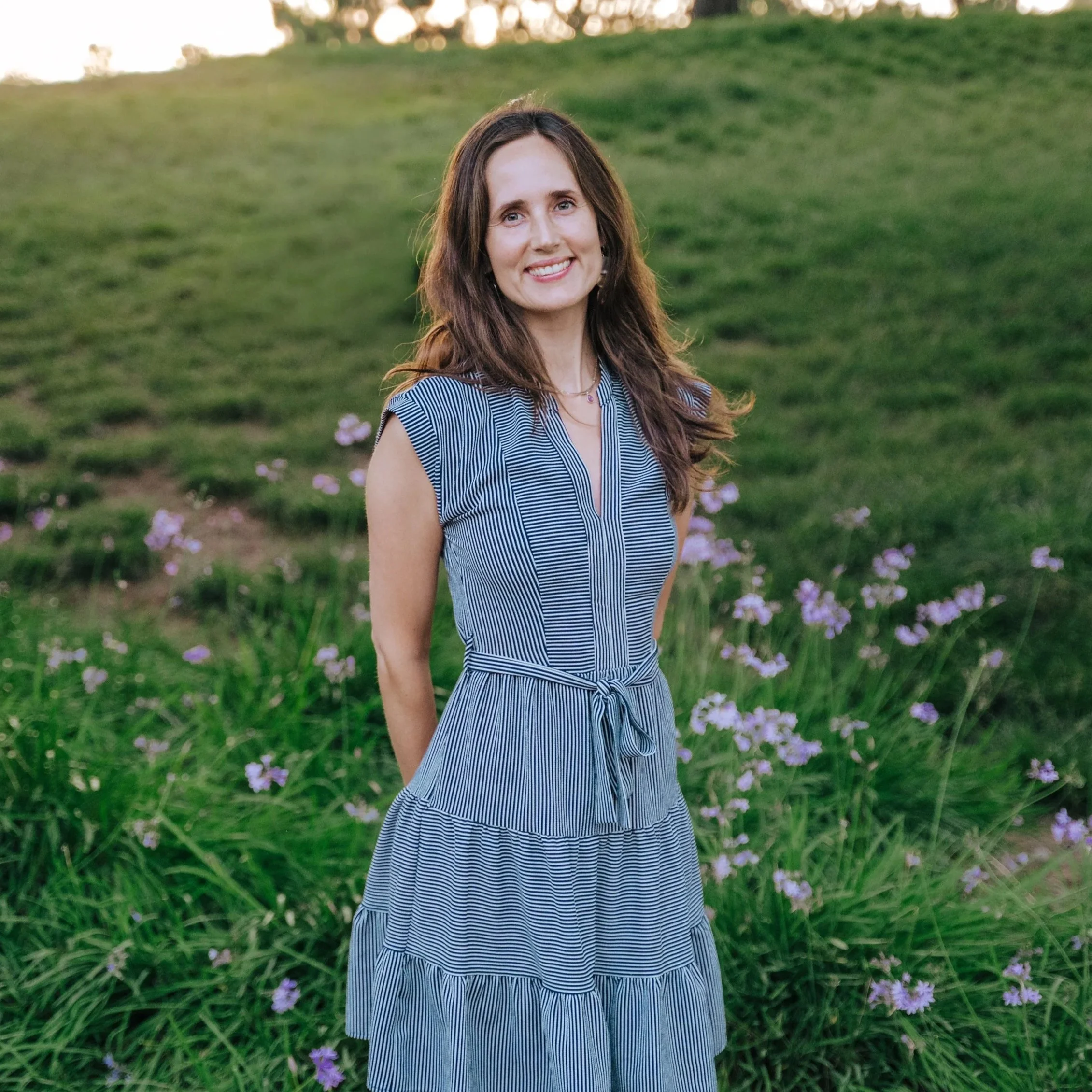 Birth Doula standing in a field of flowers