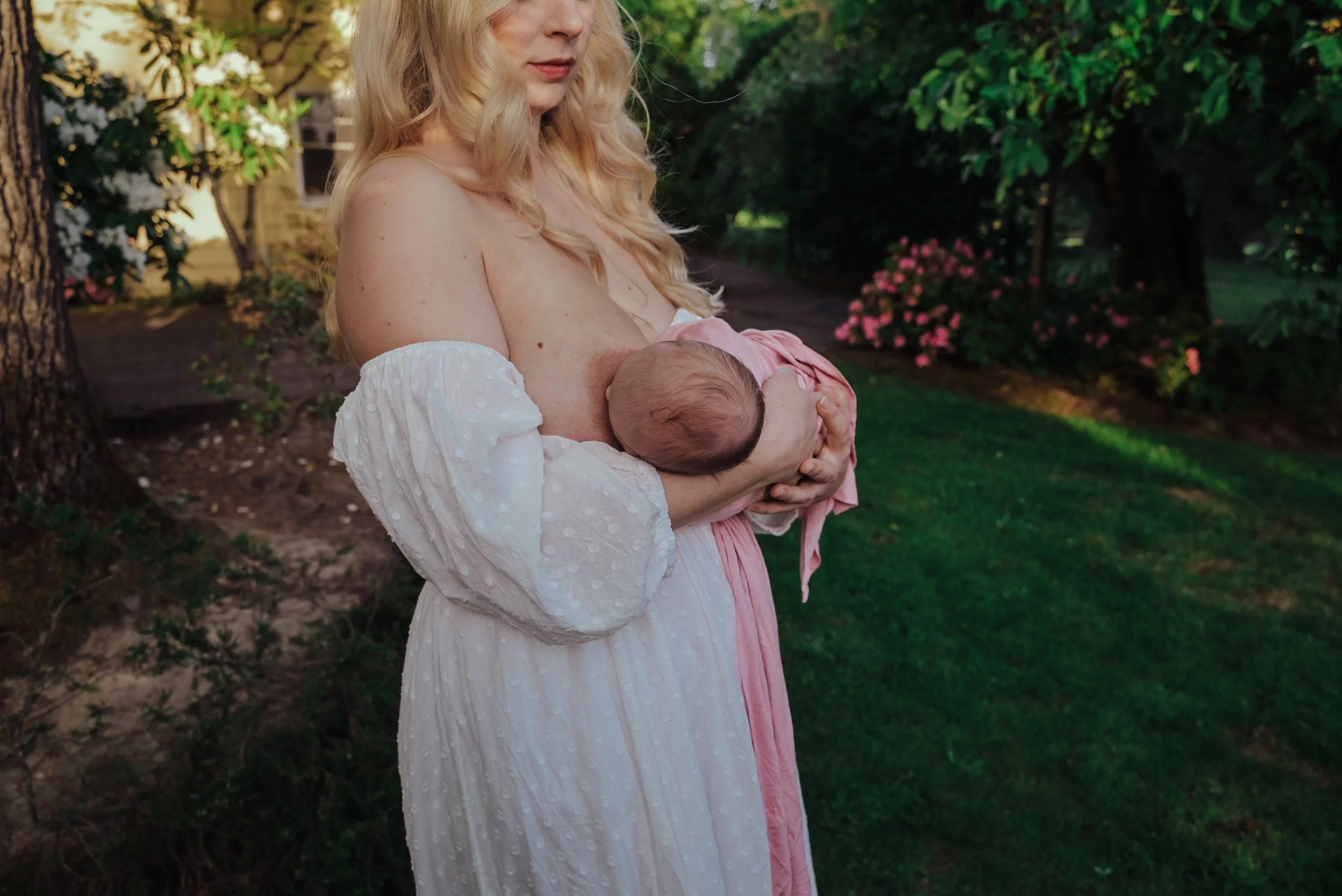 New mother breastfeeding her baby in her Portland home