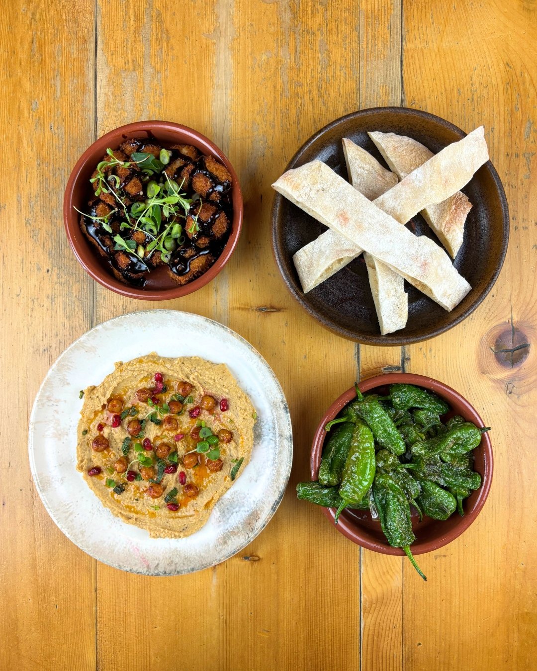 Nibbles 😋

- Hummus, spiced chickpeas, mint, pomegranate &amp; flatbread (V)
- Padron peppers (VE)
- Breaded pork belly bites, soy &amp; honey dip

🍲 Check out our menu and book a table (links in bio)