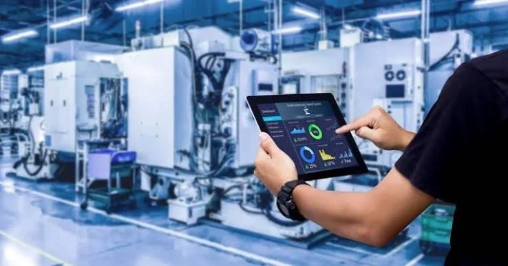 Technician monitoring facility equipment performance on a tablet