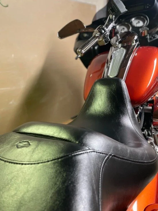 Orange motorcycle seat and tank detailed with leather care and bike detailing in Palm Coast, FL