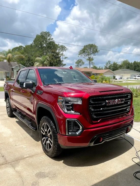 Red GMC truck after premium detailing, wax protection, and shine by Christal Clean in Palm Coast, FL
