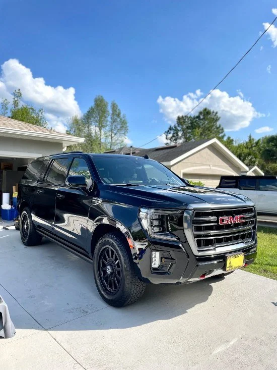 Black SUV with glossy shine after car detailing and paint correction by Christal Clean in Palm Coast