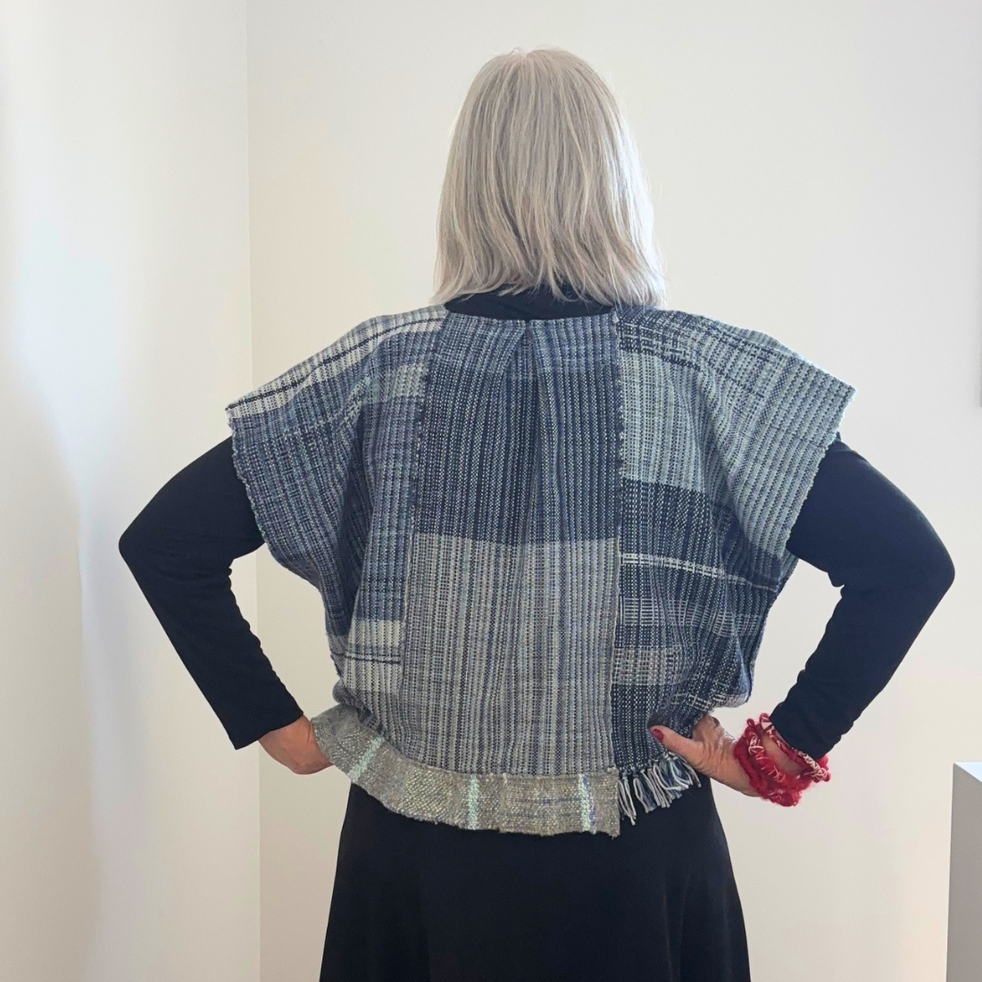 blue woven top back hands on hips.png
