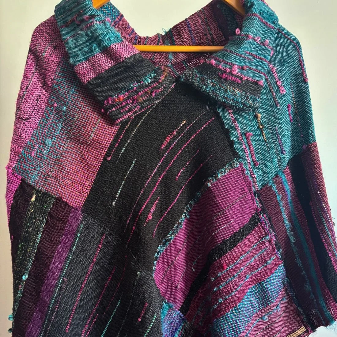 purple teal poncho on hanger top.jpg