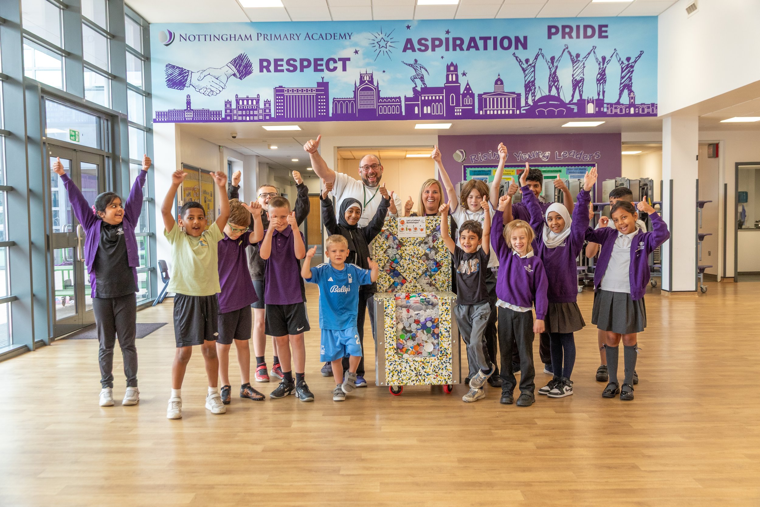 Pupils at Nottingham Primary Academy with a filled bottle top collector