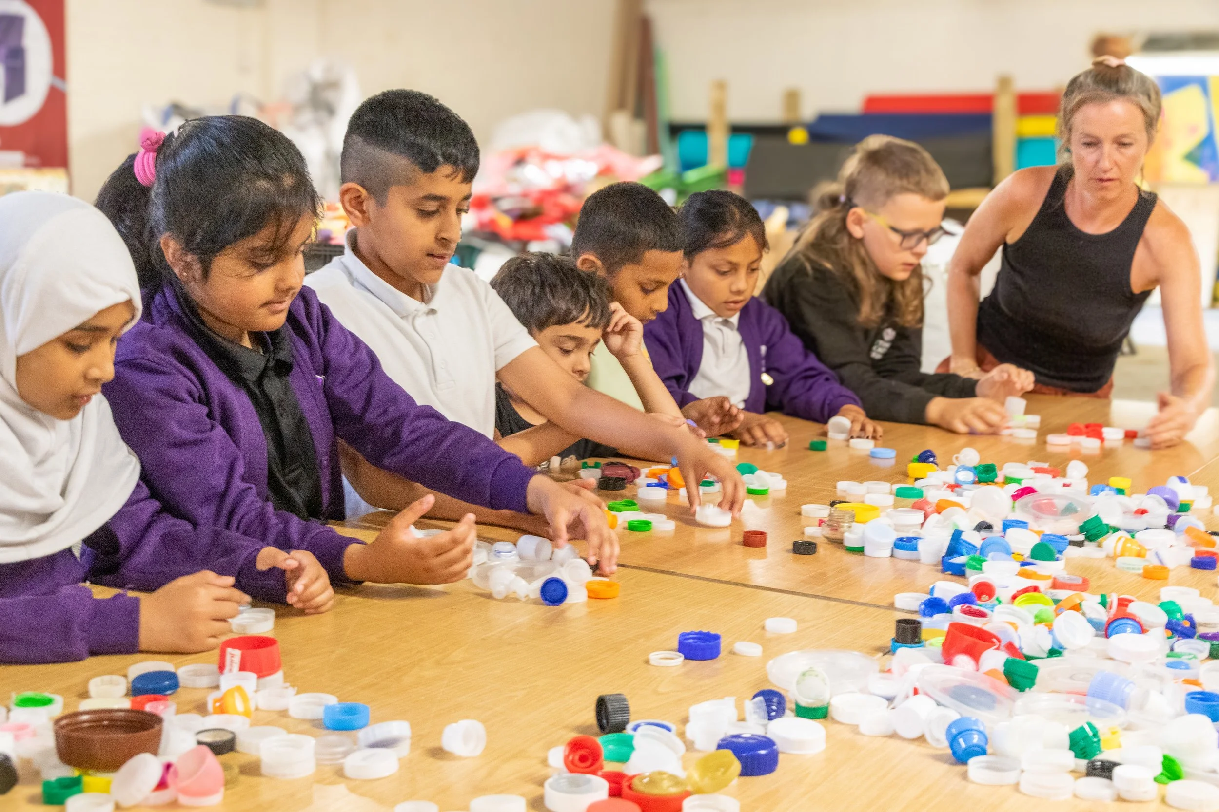 Eco Leaders counting a sample of bottle tops