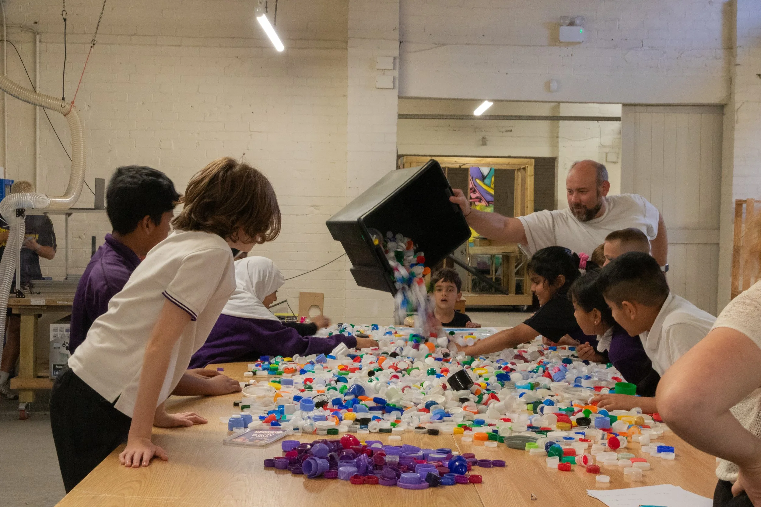 Eco Leaders sorting their school colour purple form the bottle tops