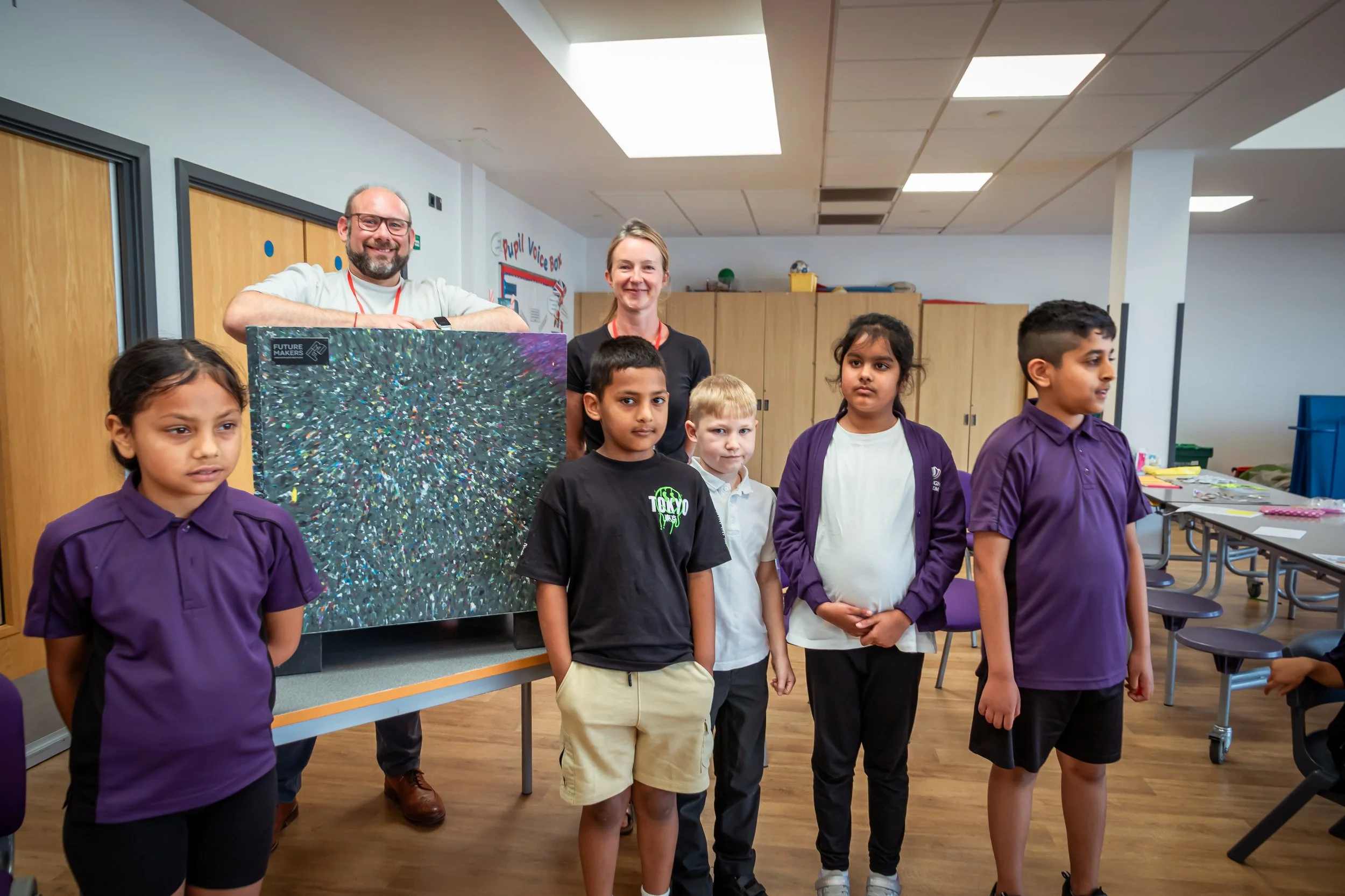 Eco Leader standing at the front with unveiled planter with Tristan and Gill